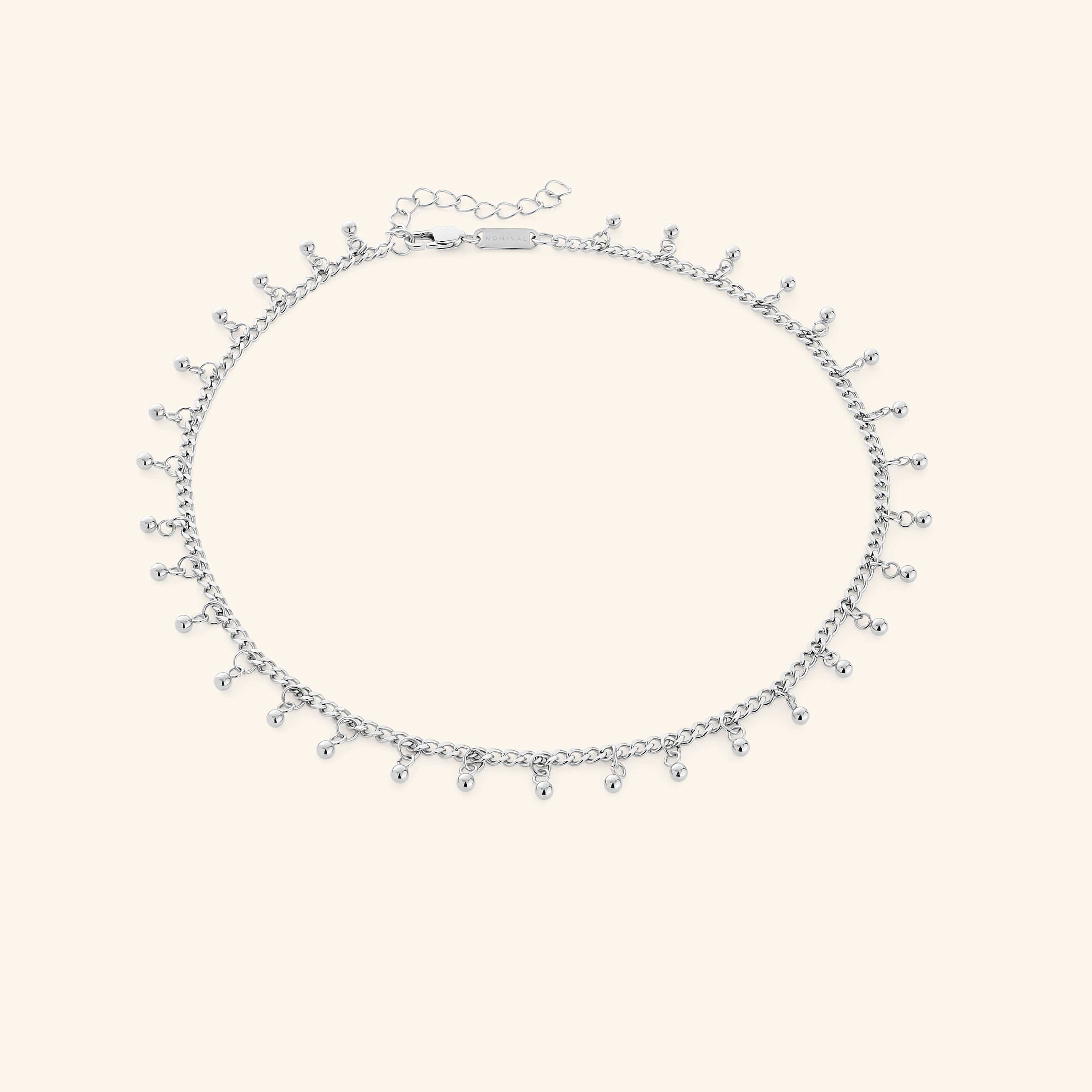 Close-up of Luna Dot Drop Choker lying flat with dotted charm detail visible — a minimalist choker design