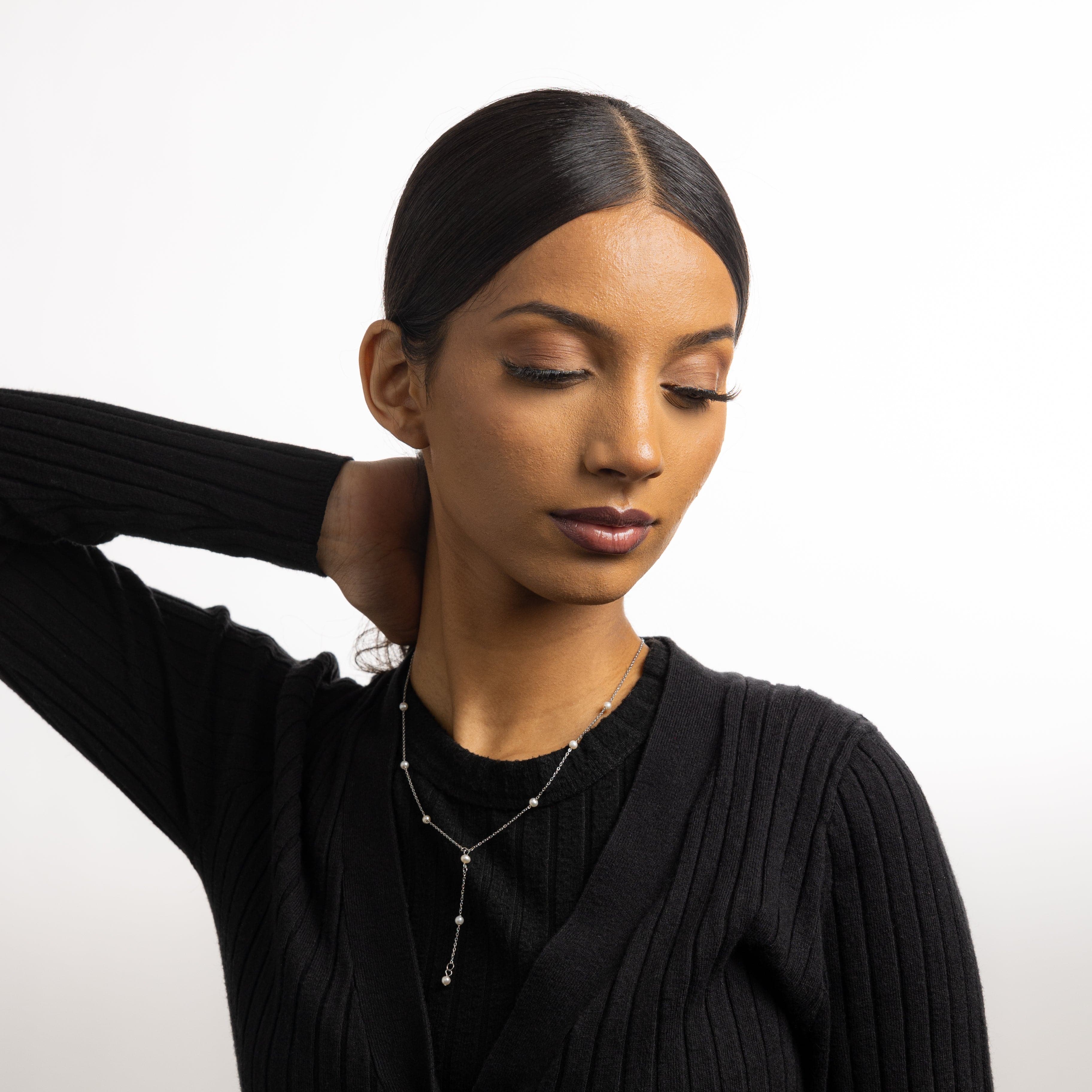 Model wearing the luxury jewelry piece against a neutral background, showcasing its everyday elegance