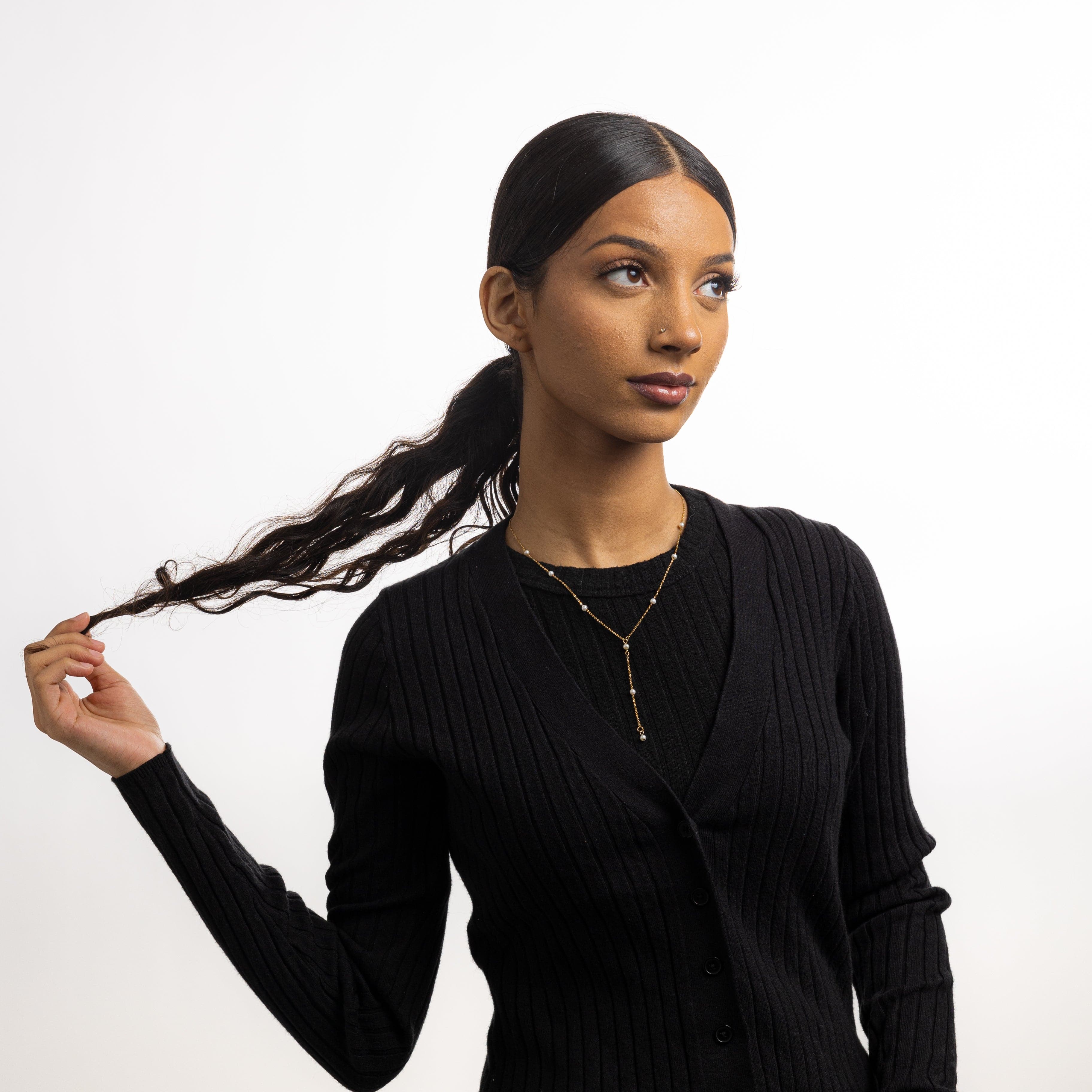 Model wearing the luxury jewelry piece against a neutral background, showcasing its everyday elegance
