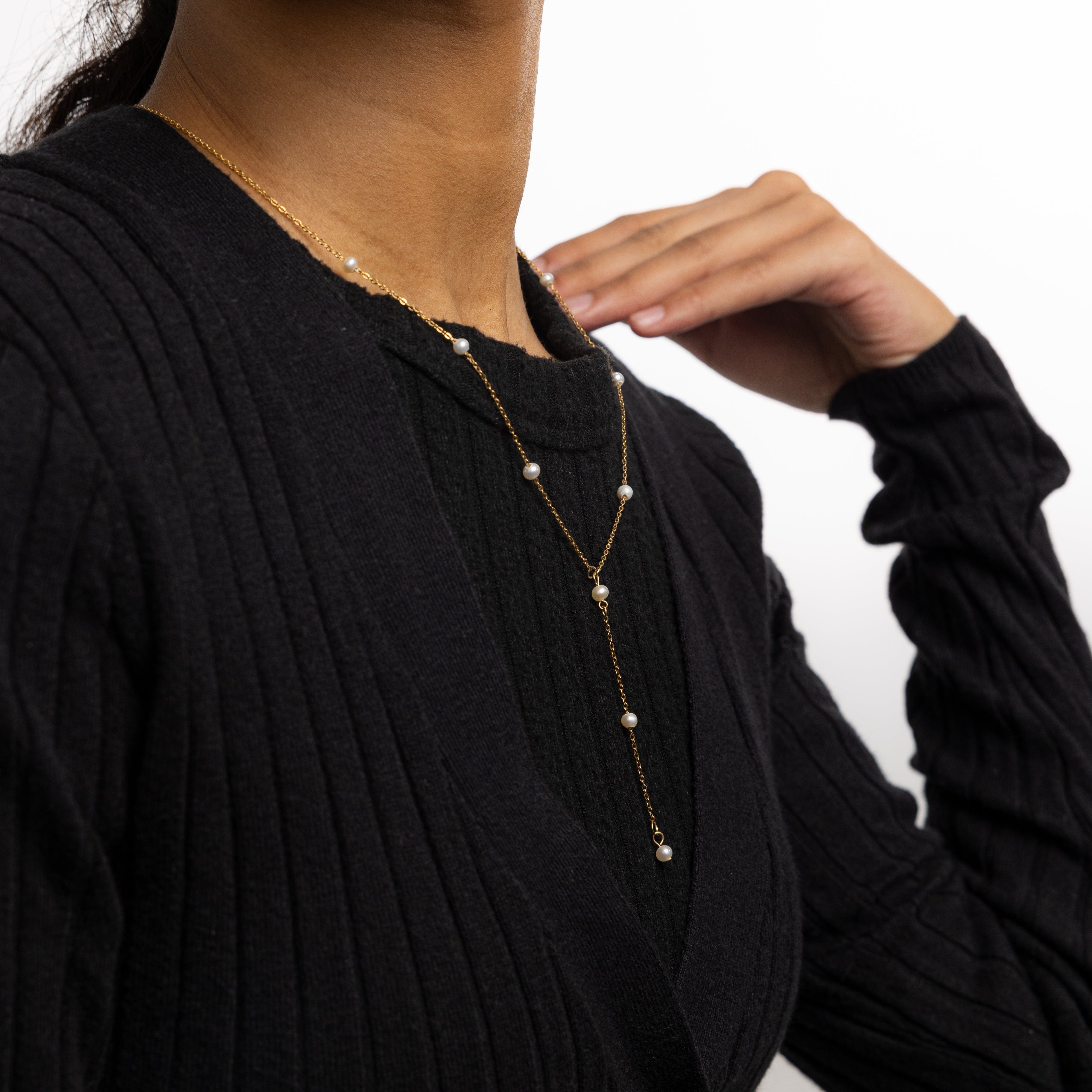 Model wearing the luxury jewelry piece against a neutral background, showcasing its everyday elegance