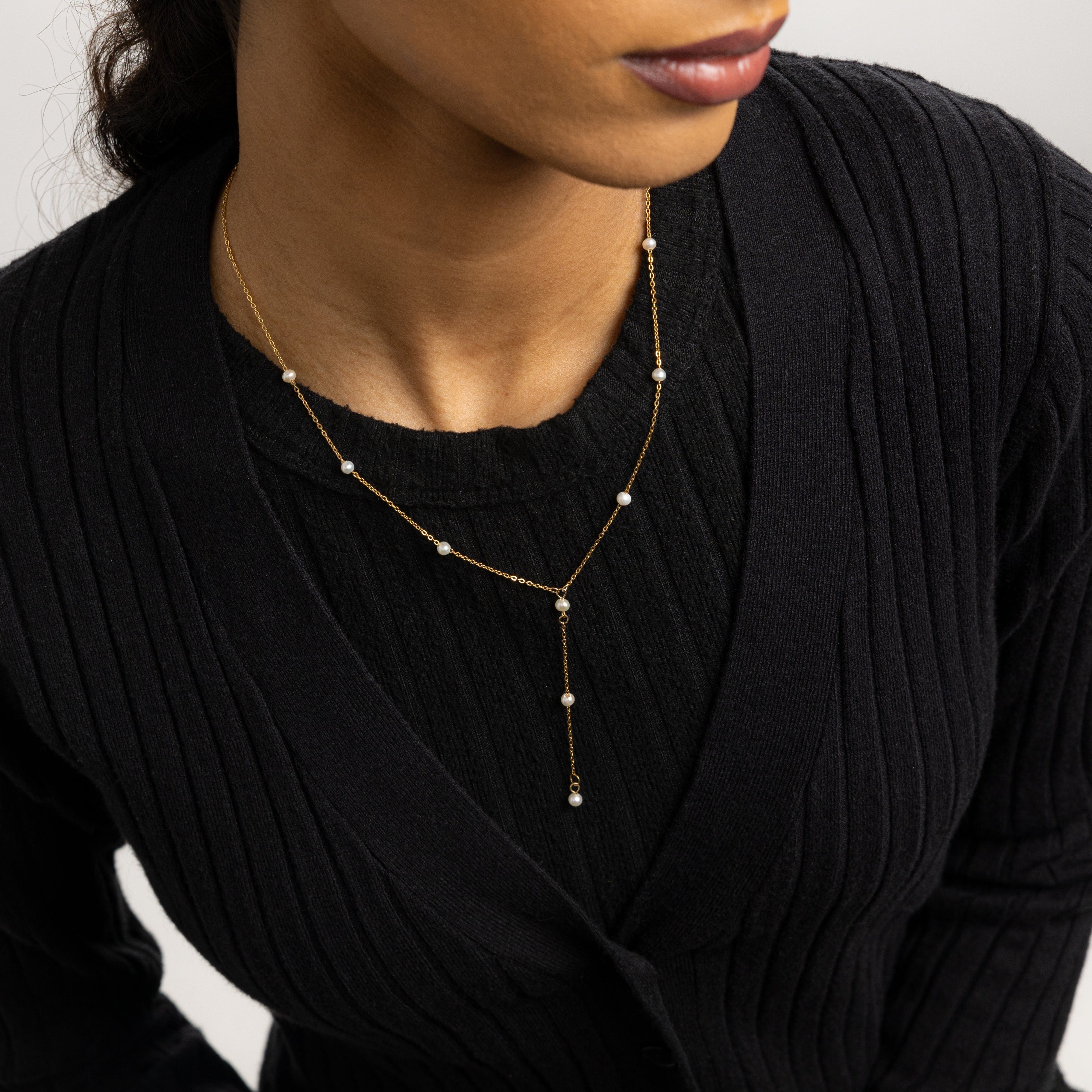 Close-up of pearl necklace highlighting 4mm freshwater pearls and lariat drop