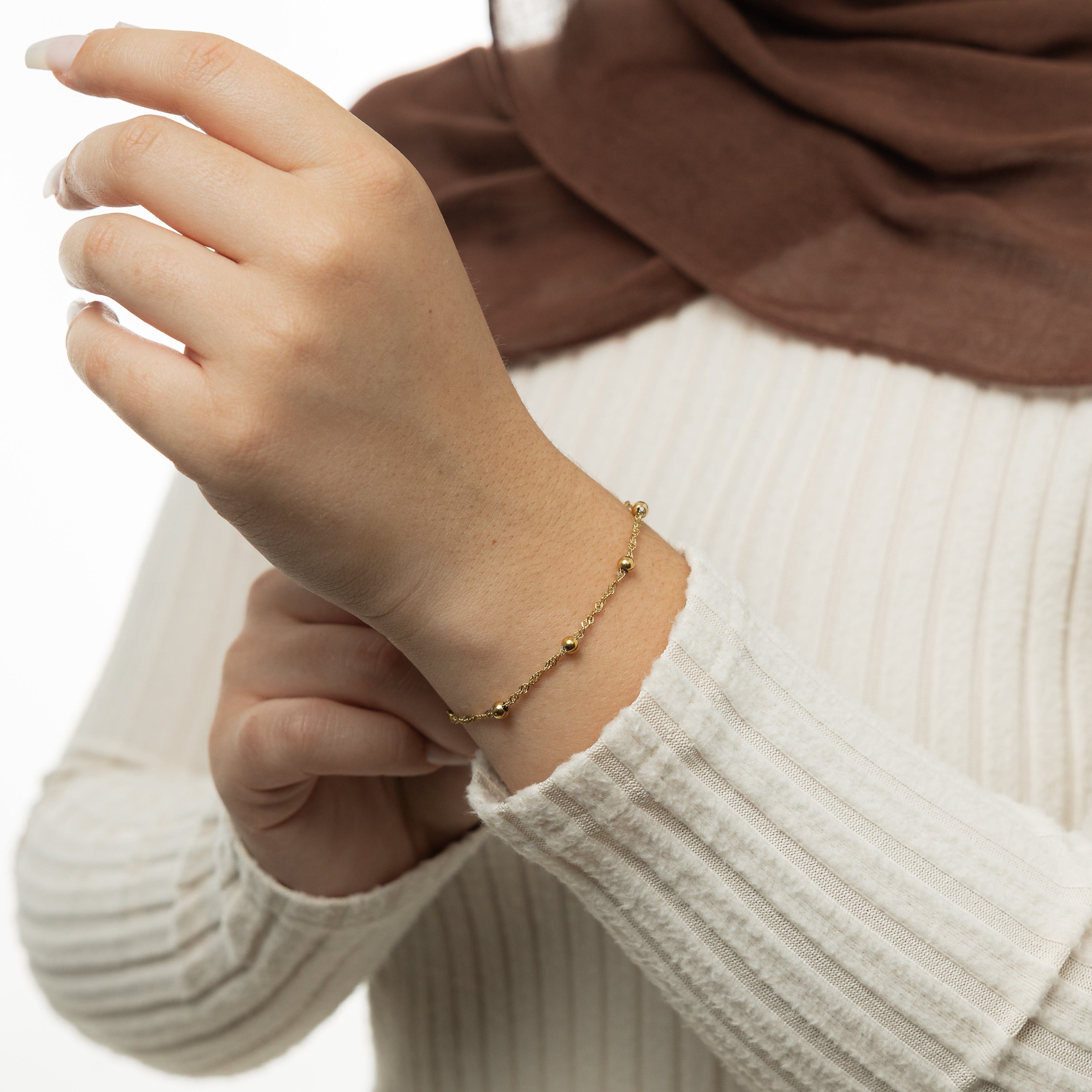Elegant Dotted Twisted Bracelet displayed in its velvet pouch, emphasizing its luxurious design.