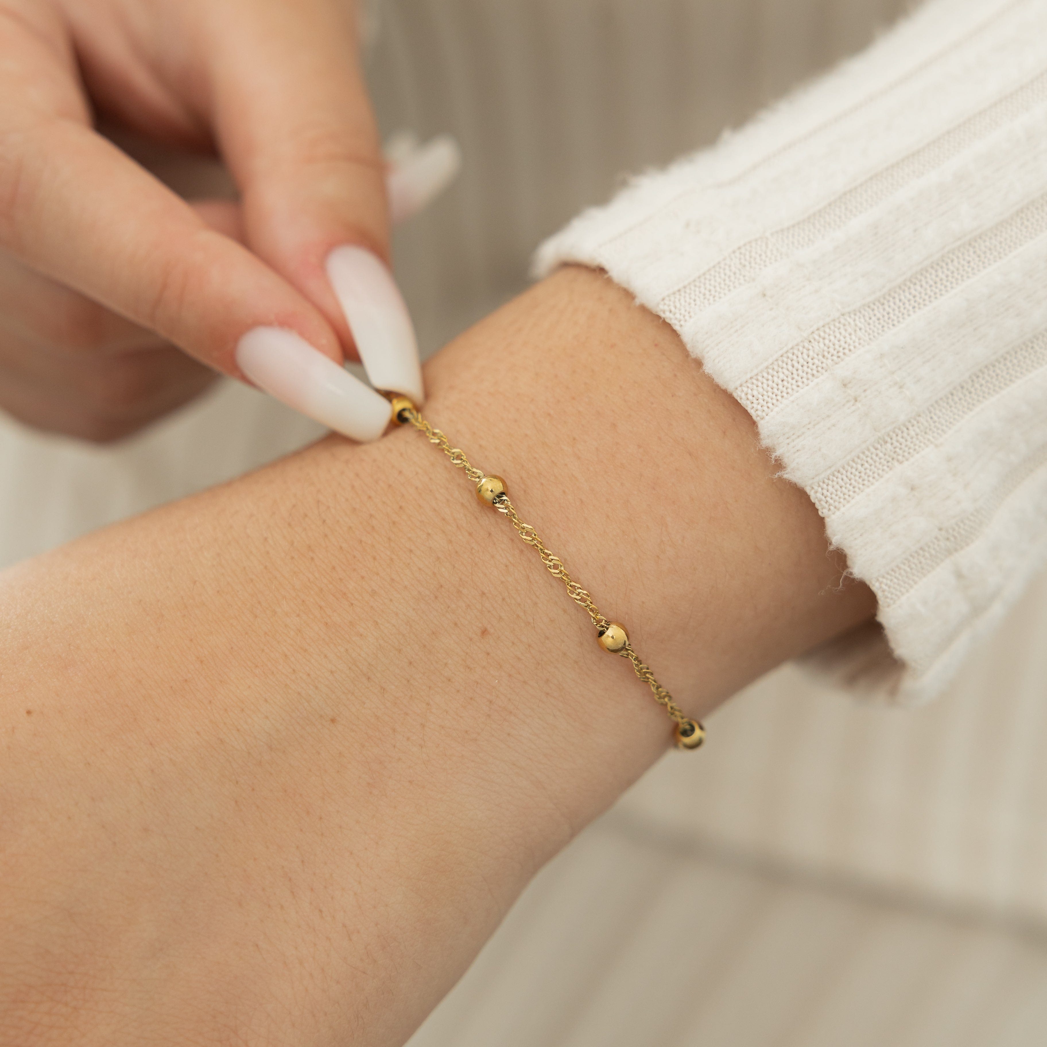 Model wearing the Elegant Dotted Twisted Bracelet during a casual outing.