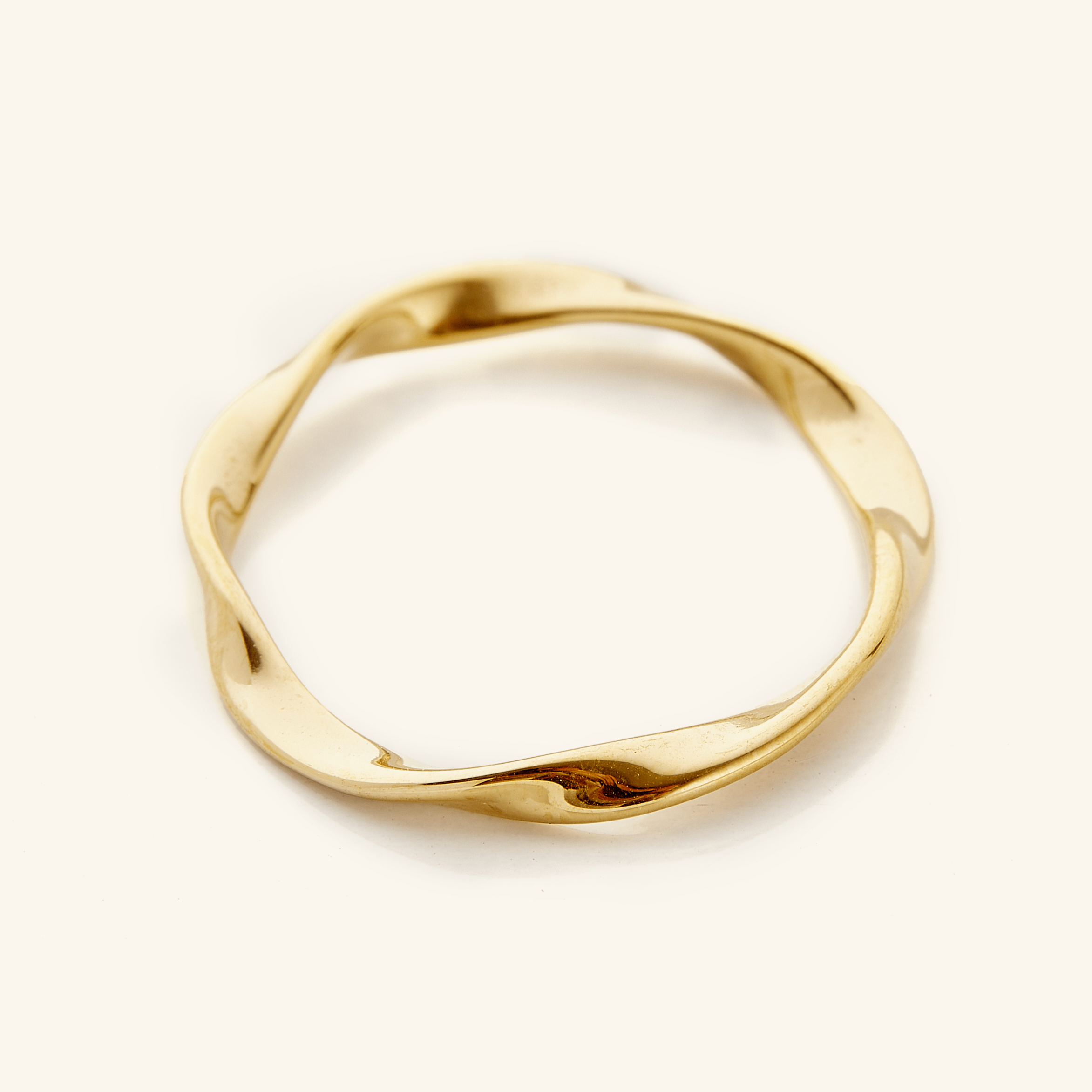 Ripple Effect Minimalist Gold Ring shown on a model's hand in natural light.