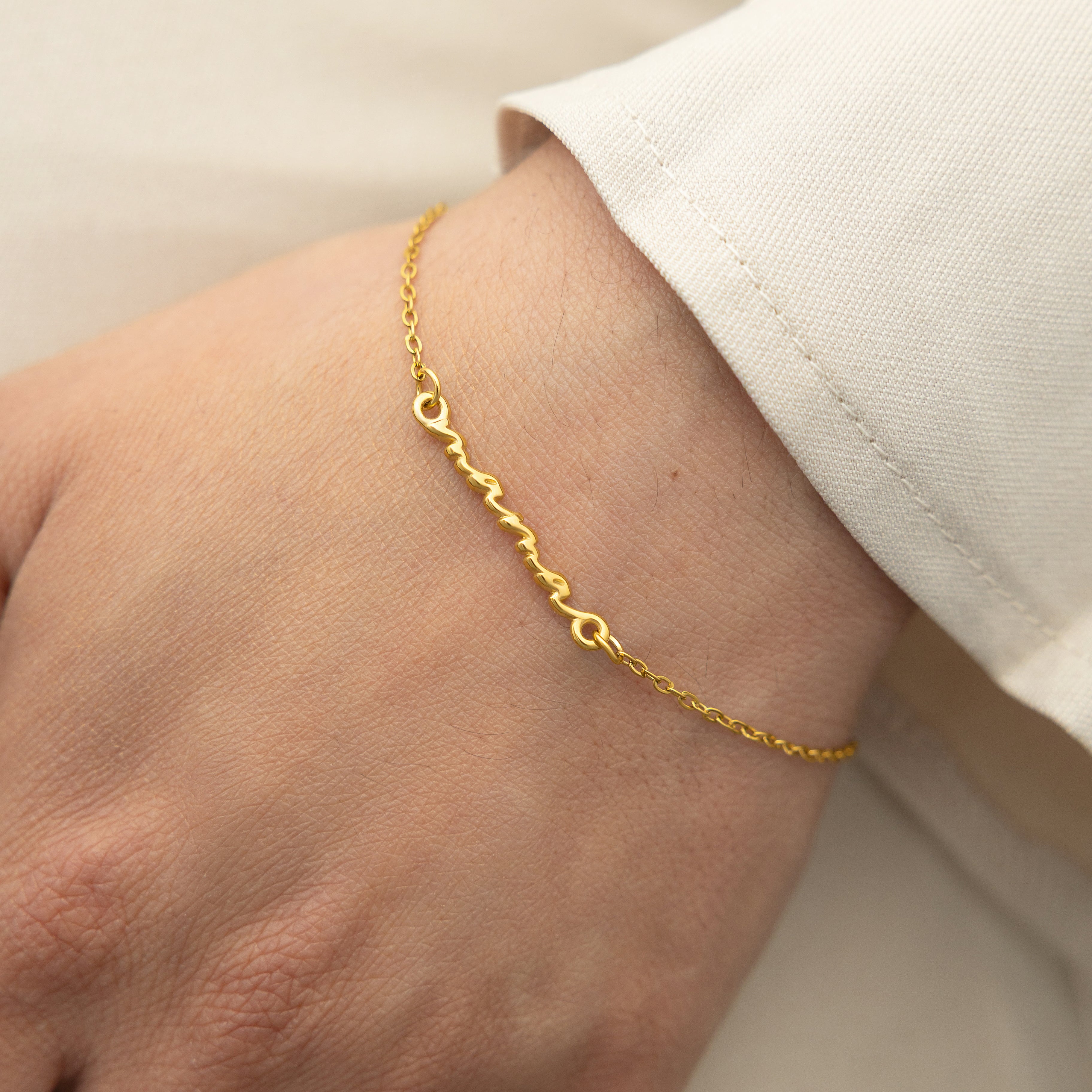 Close-up view of the Affordable Gold Mama Bracelet on a velvet pouch.