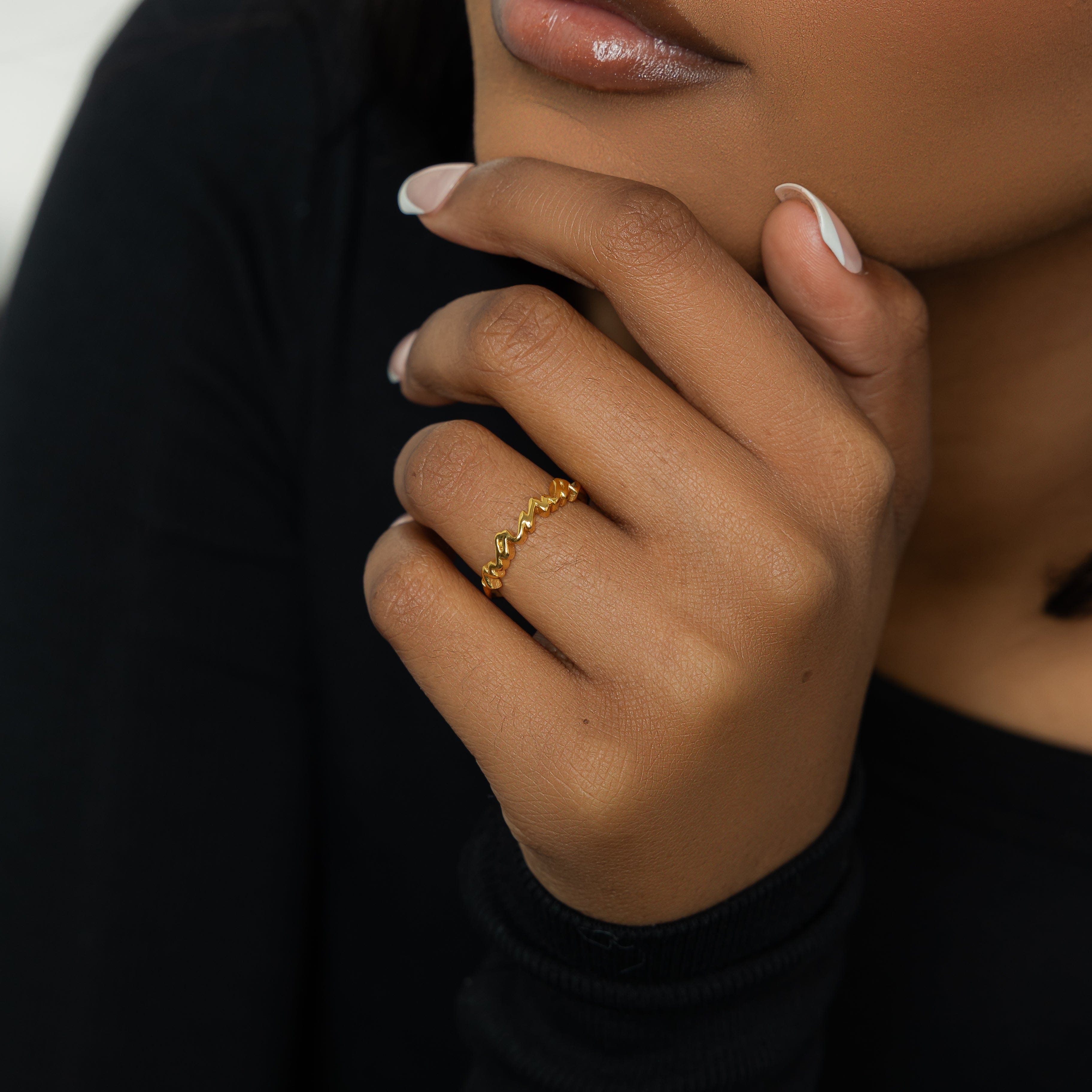 Mamas Heart Gold Band displayed elegantly against a soft velvet backdrop.
