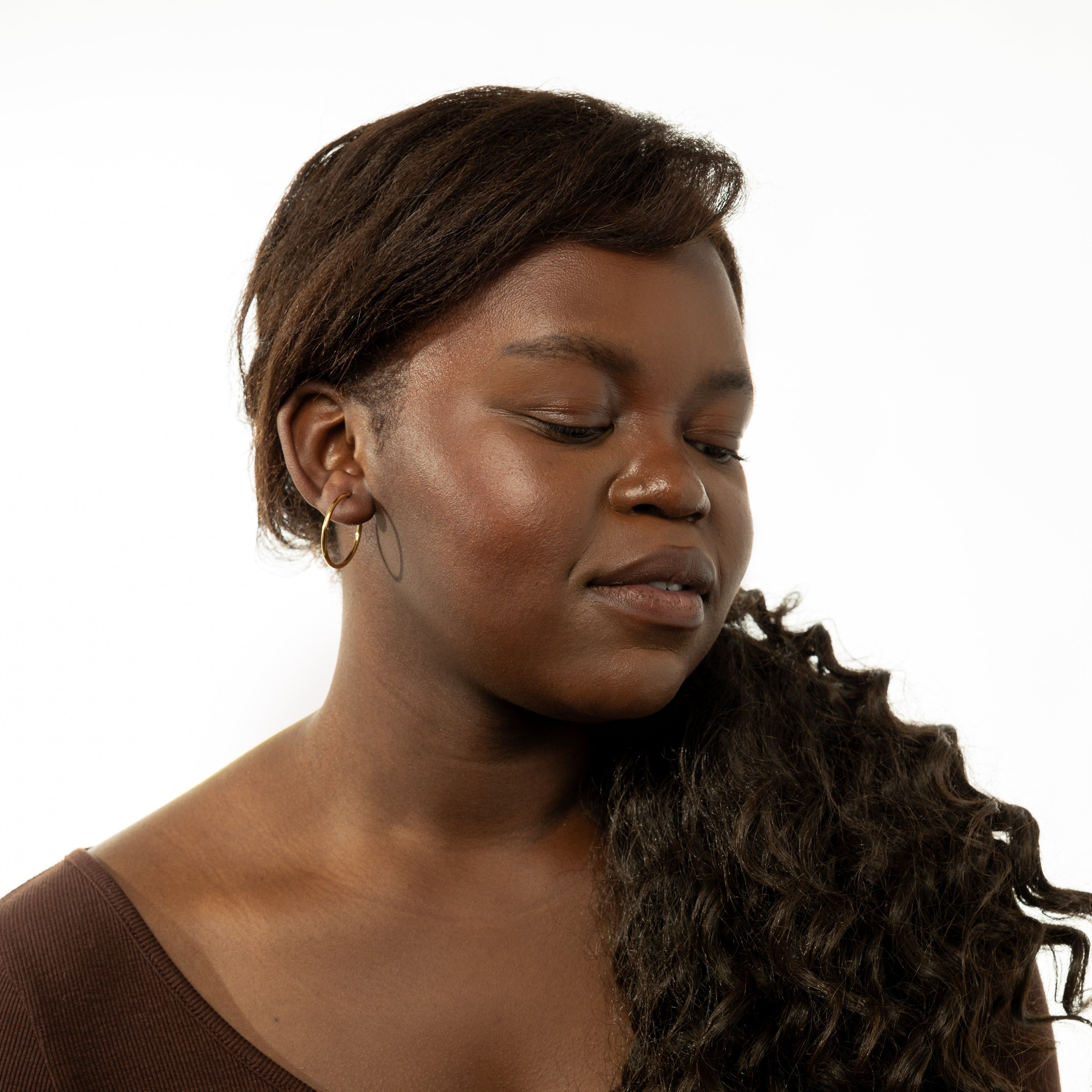 A model wearing gold hoop earrings at a night out, demonstrating their versatility.