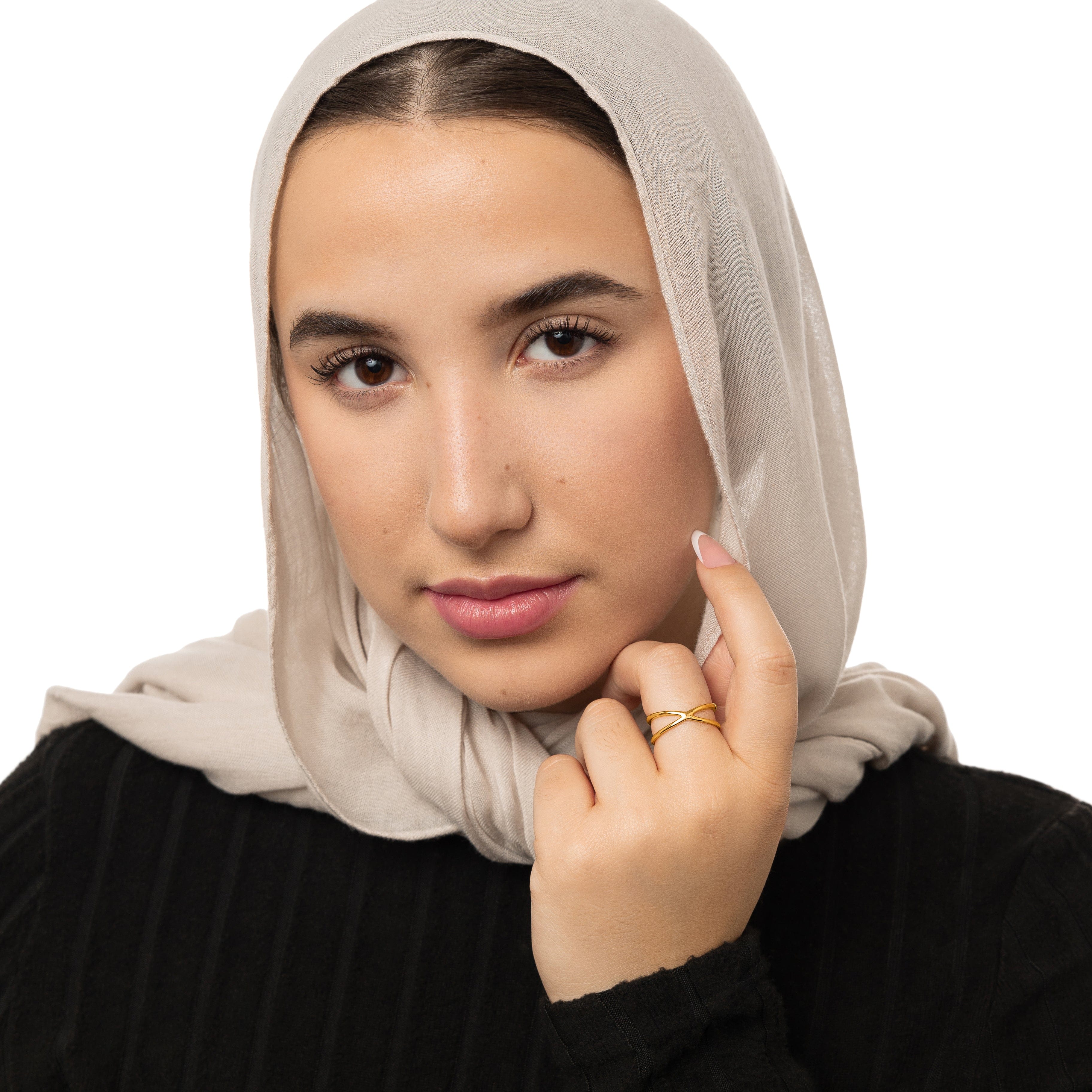 Elegant Intersection Minimalist Ring displayed in velvet pouch, emphasizing its premium packaging.