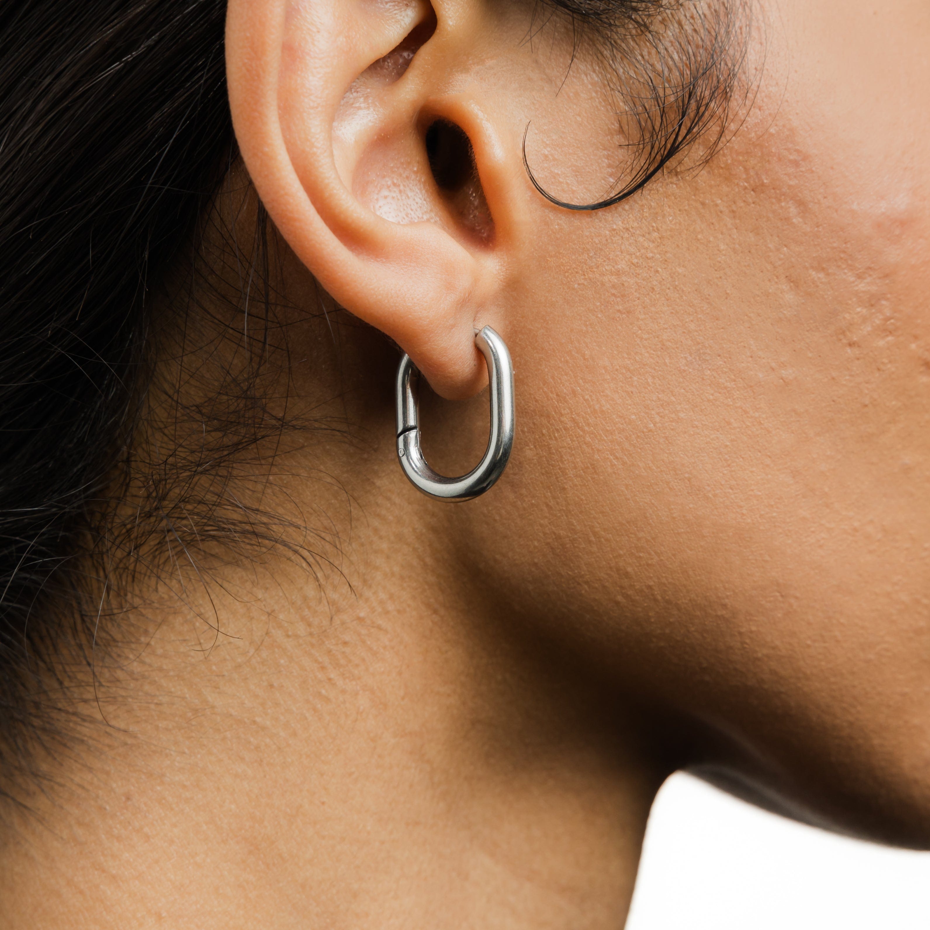 Model wearing Essential Gold Oval Hoop Earrings with a casual outfit.