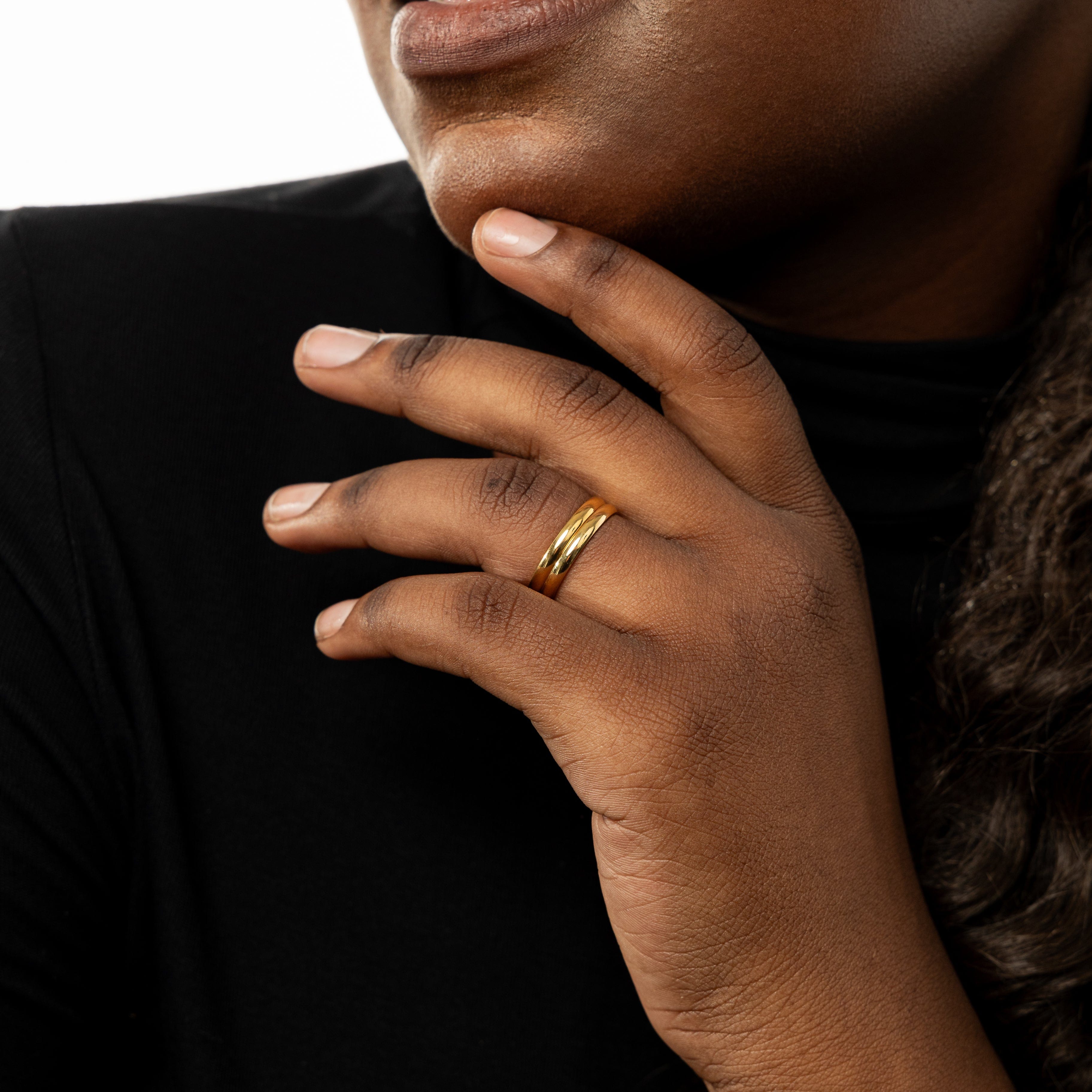 Timeless thin gold ring displayed with other stackable rings
