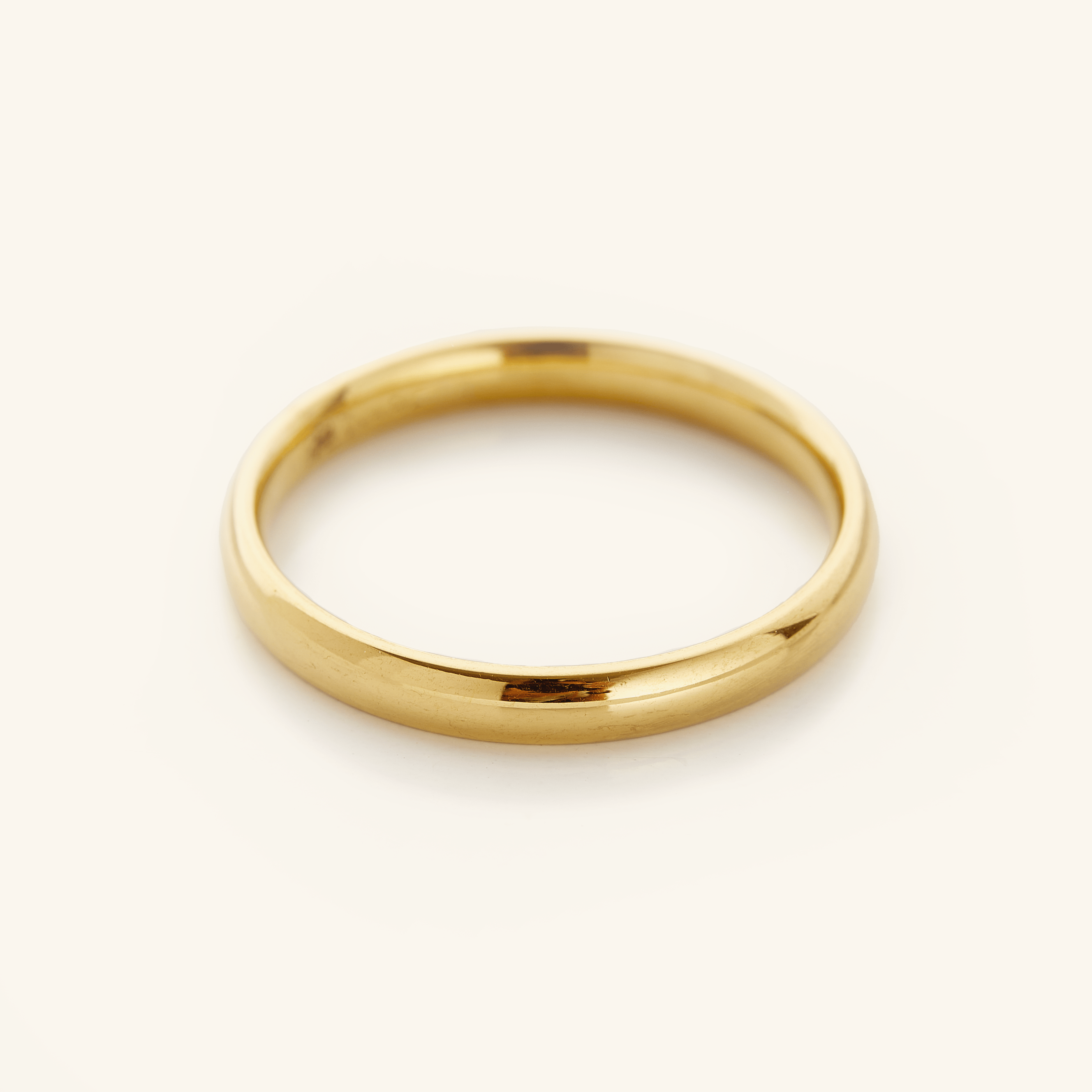 Timeless thin gold ring displayed with other stackable rings