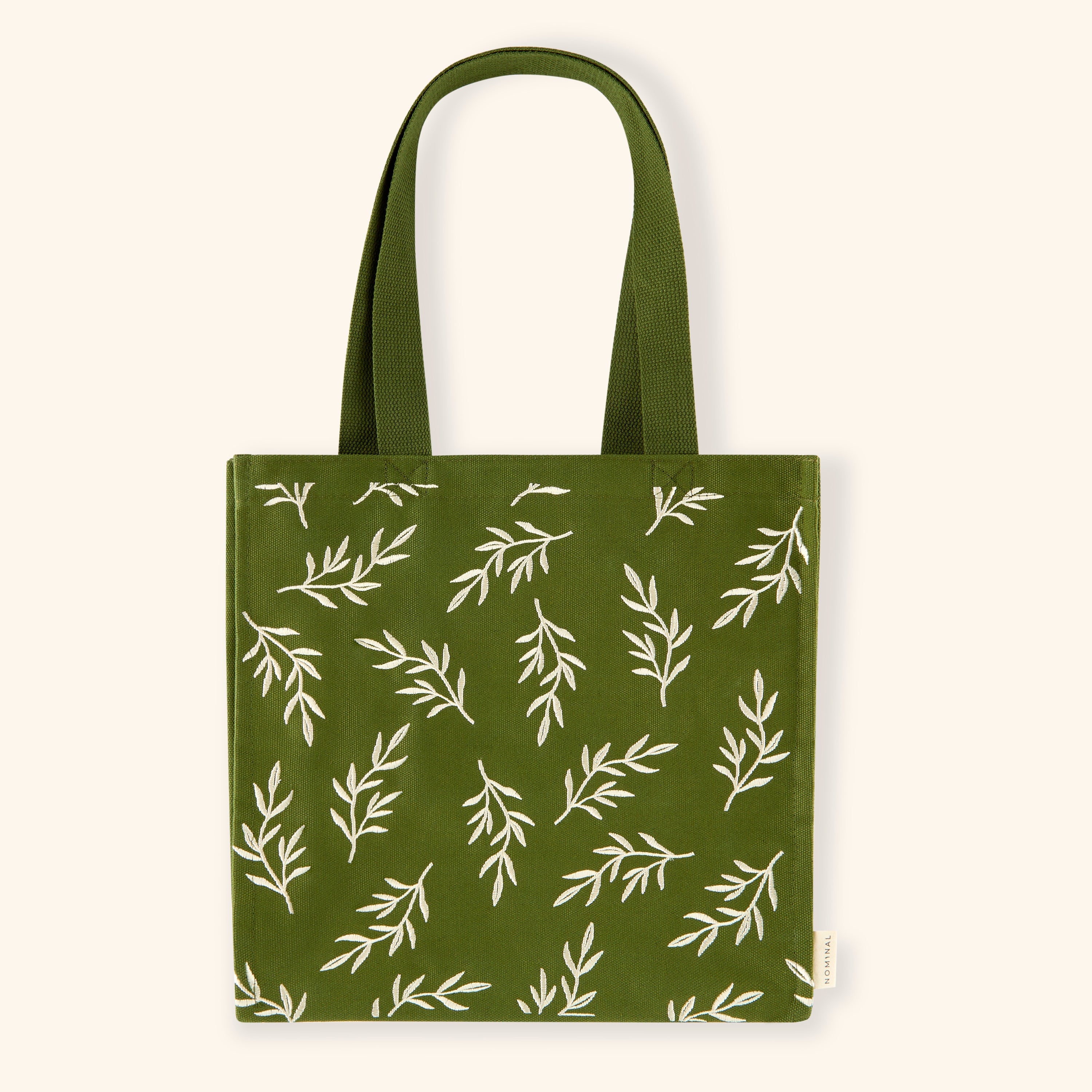Olive Branch Freedom Tote bag displayed outdoors, emphasizing its eco-friendly canvas material.
