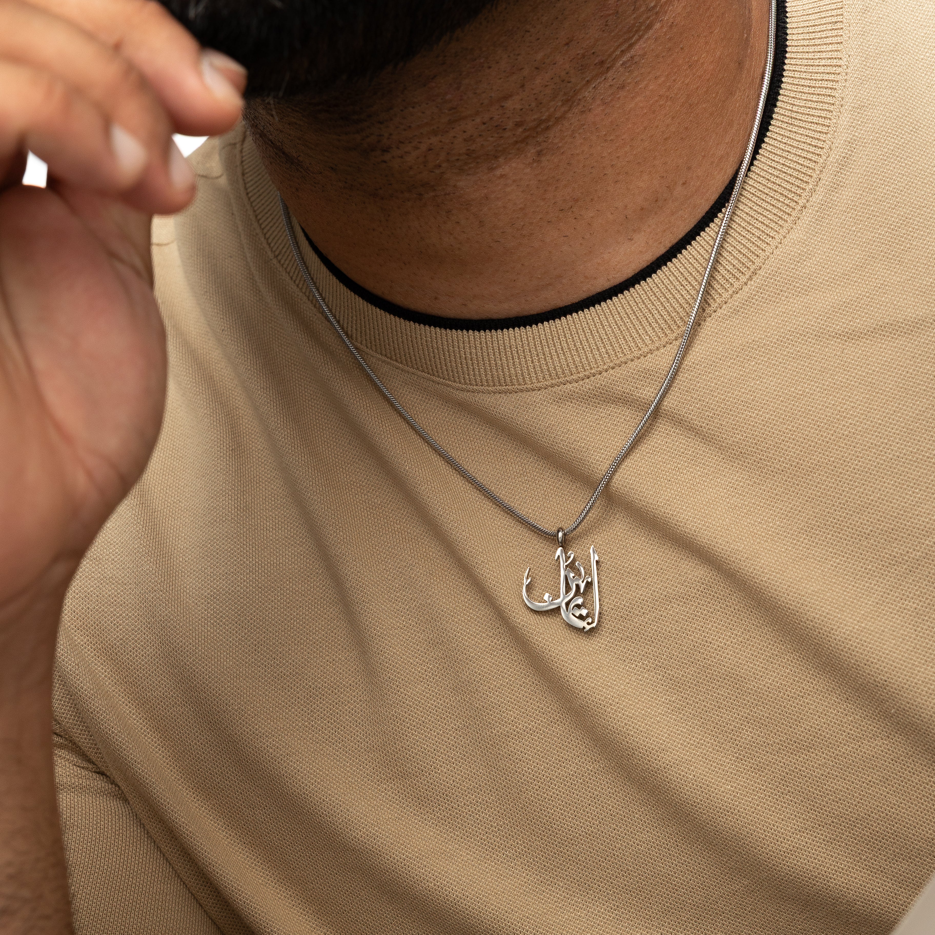 Timeless Faith Calligraphy Necklace worn by a man, highlighting its stylish appeal.