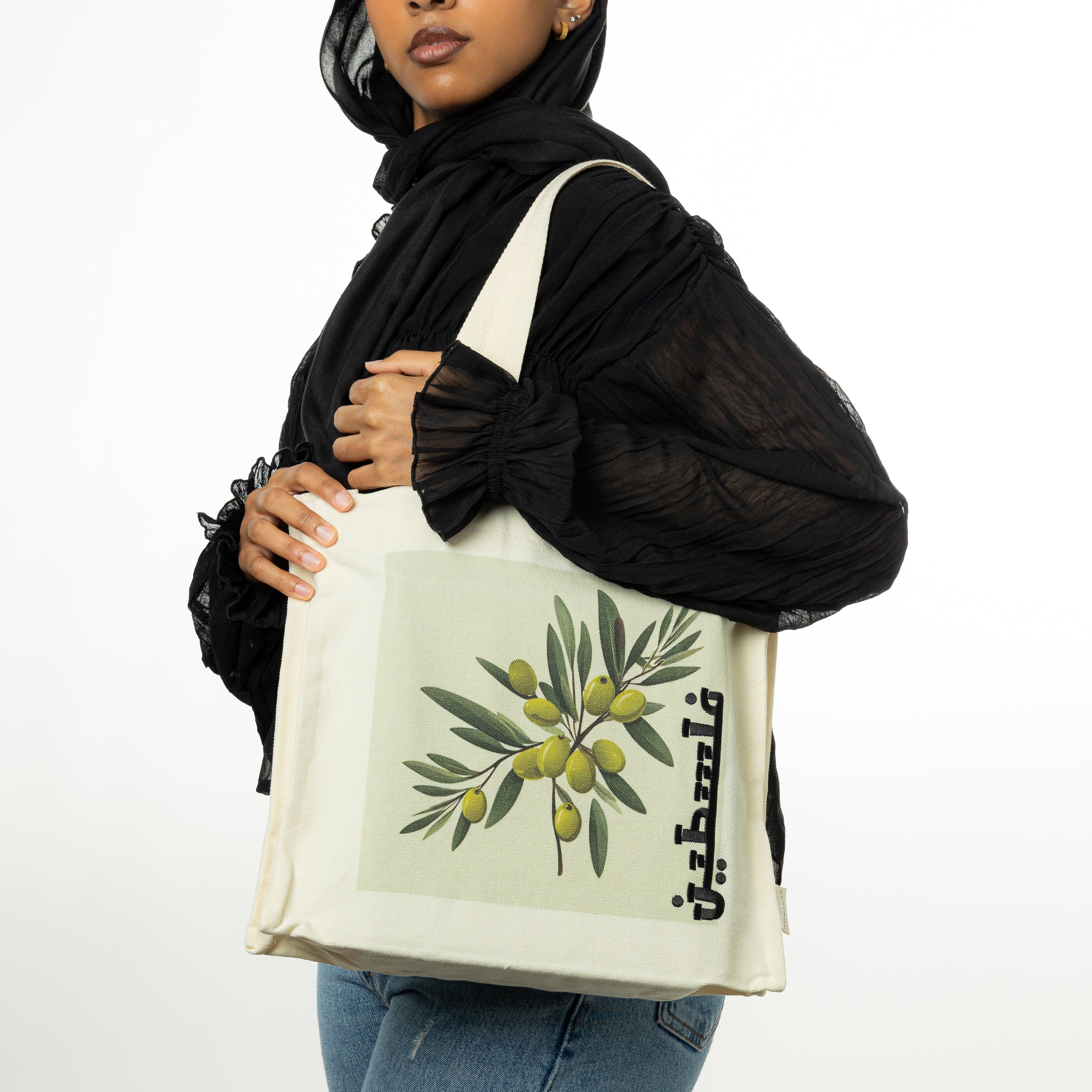 Side view of the Palestine tote with olive branch print, highlighting its spacious interior.