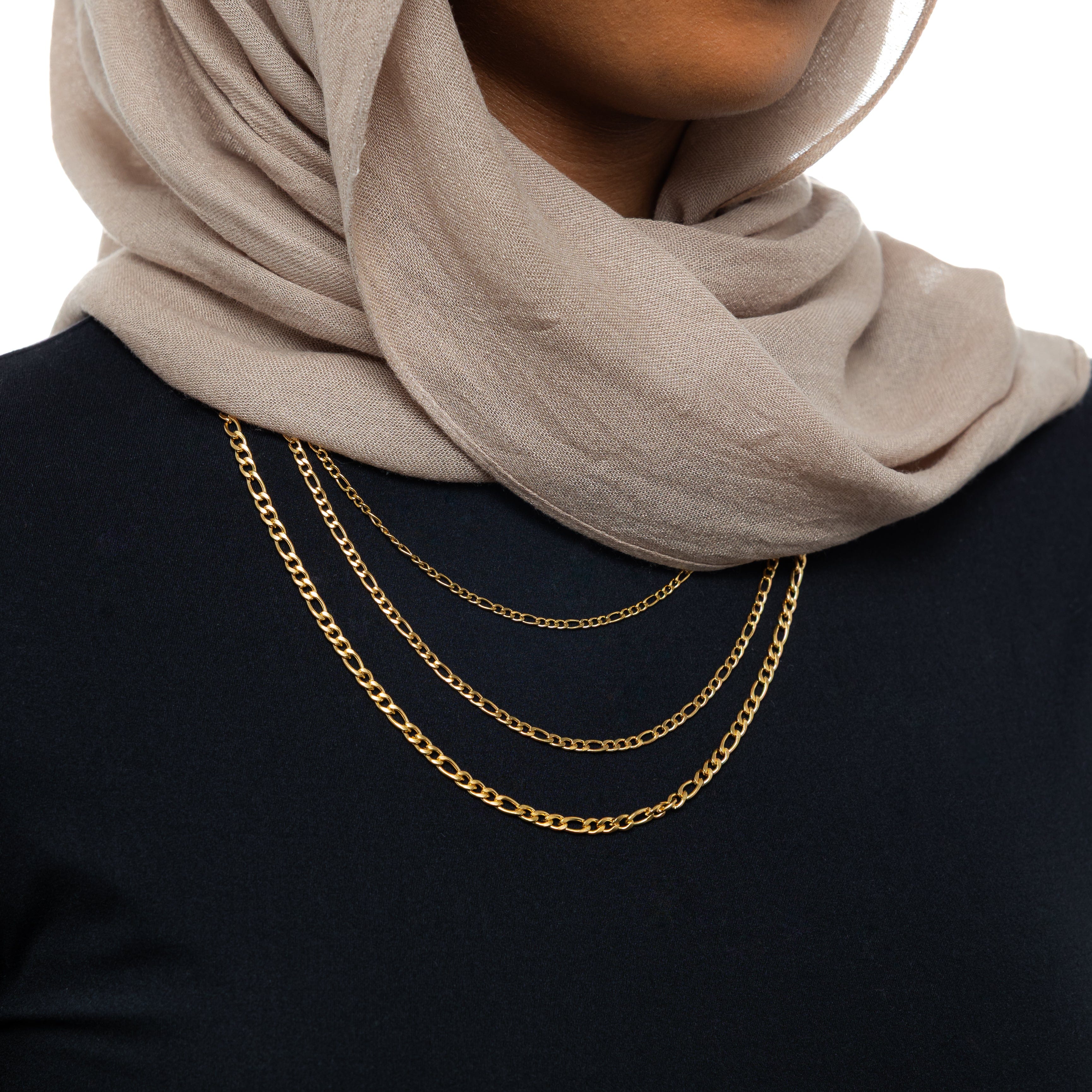 Elegant Figaro chain necklace displayed elegantly on a jewelry bust.