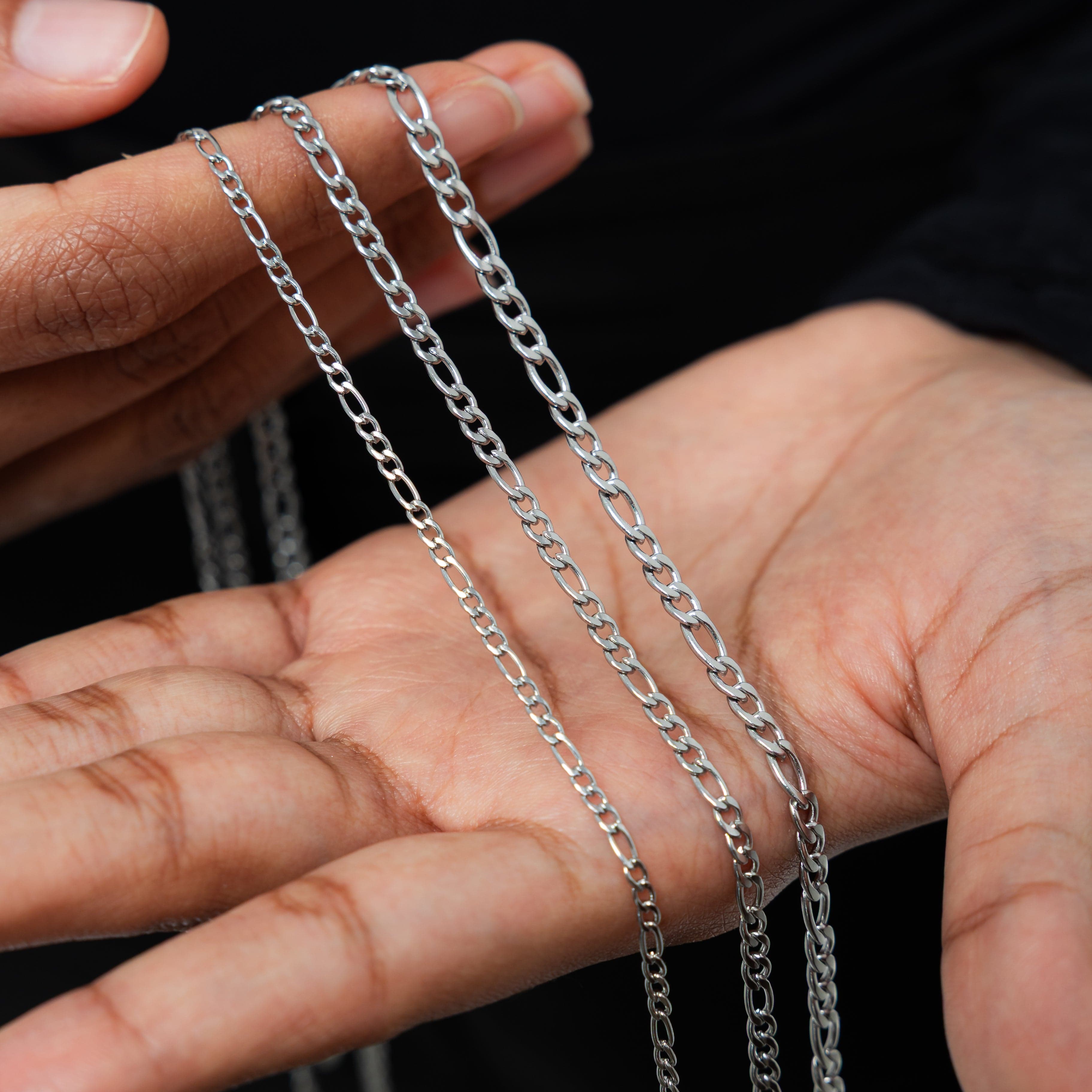 Model wearing the Figaro chain necklace, showcasing its versatility as a choker.