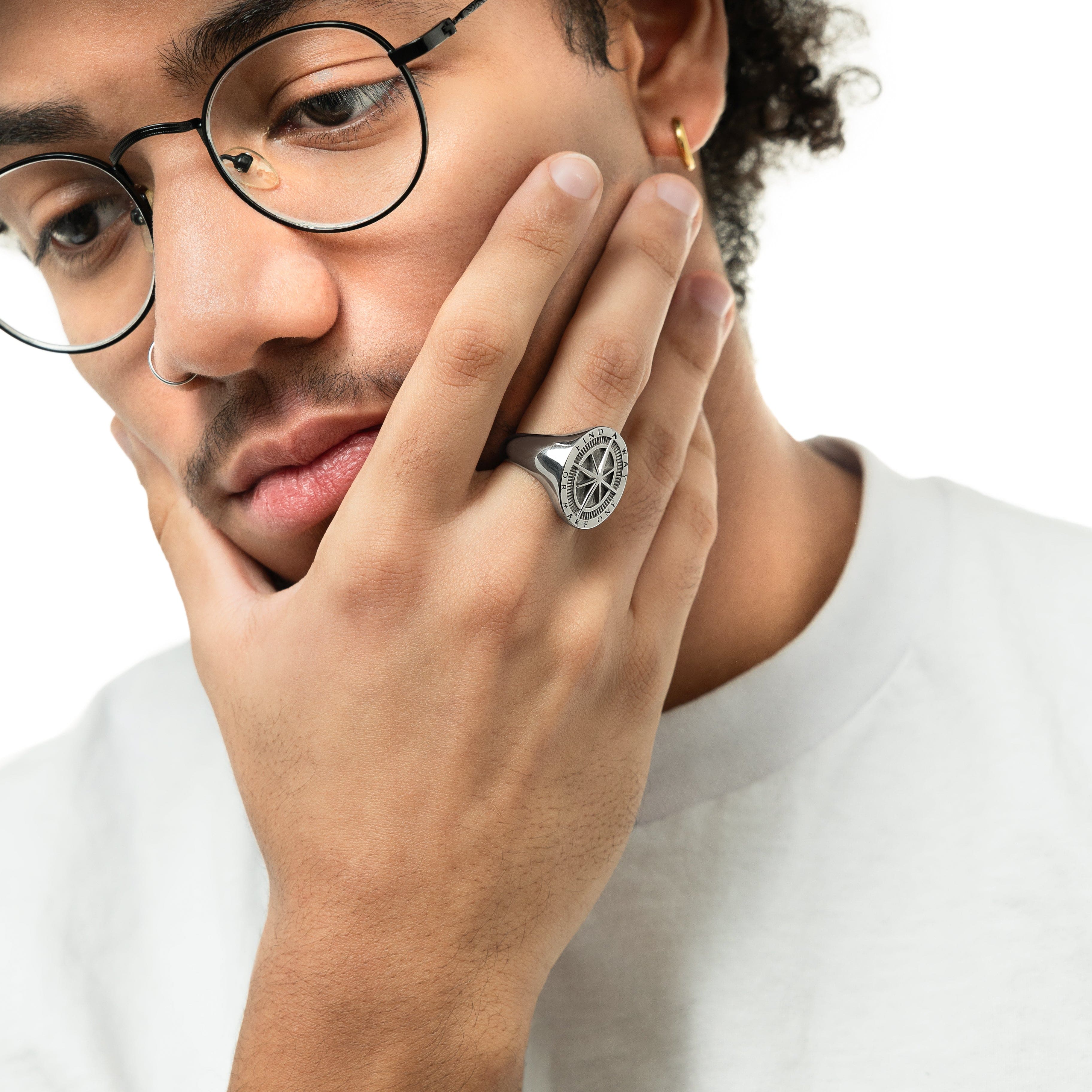 Front view of the Pathfinder stainless steel compass ring, showcasing its embossed design.