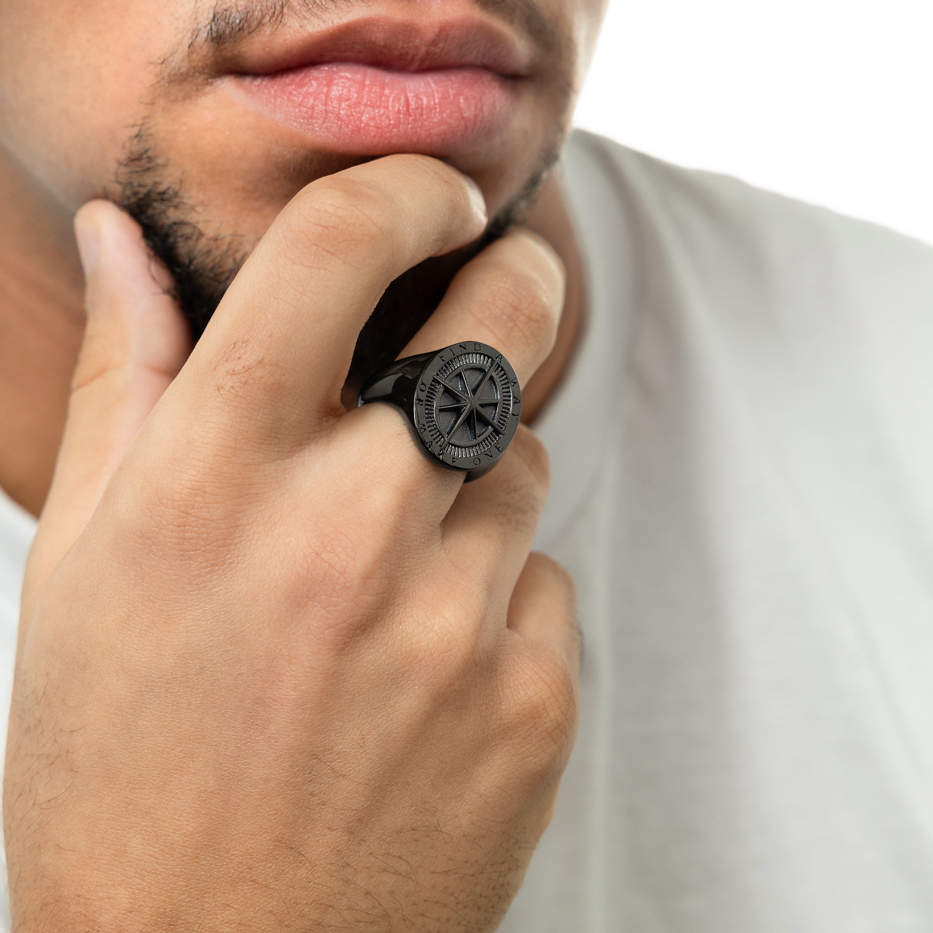 Front view of the Pathfinder stainless steel compass ring, showcasing its embossed design.