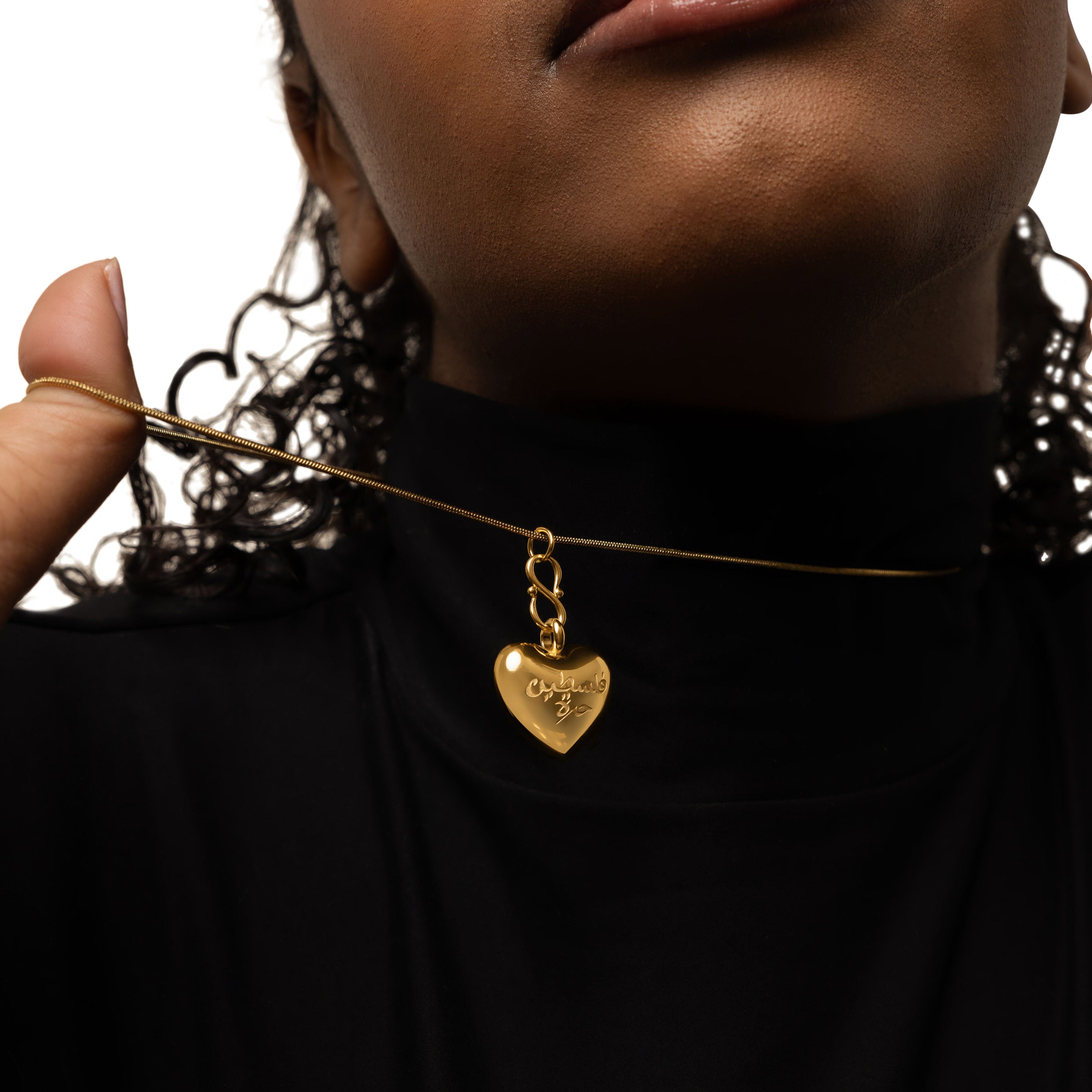 Model wearing the heart necklace, styled with casual attire for everyday use.