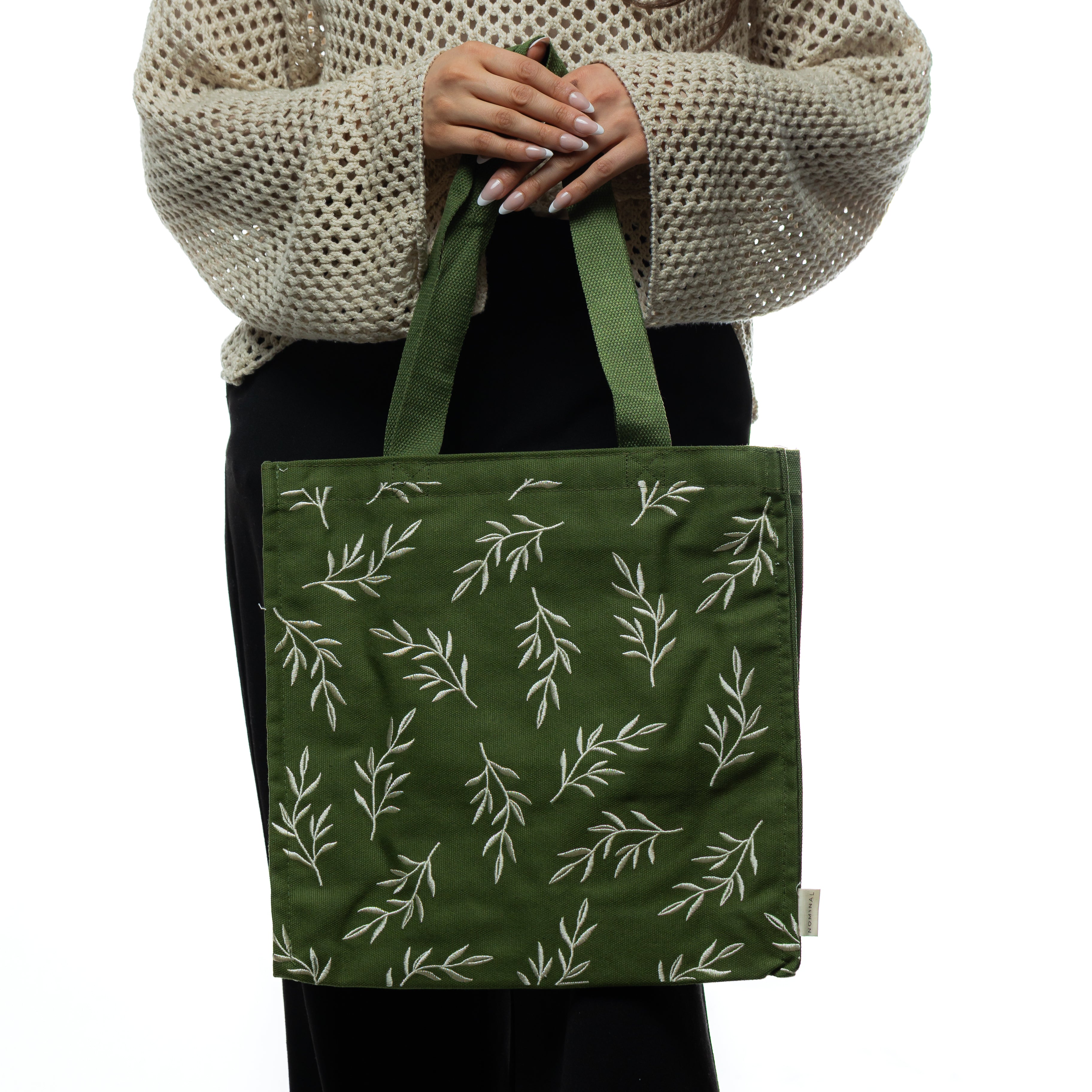 Close-up of the Olive Branch tote bag illustrating the unique stitched design of peace branches.