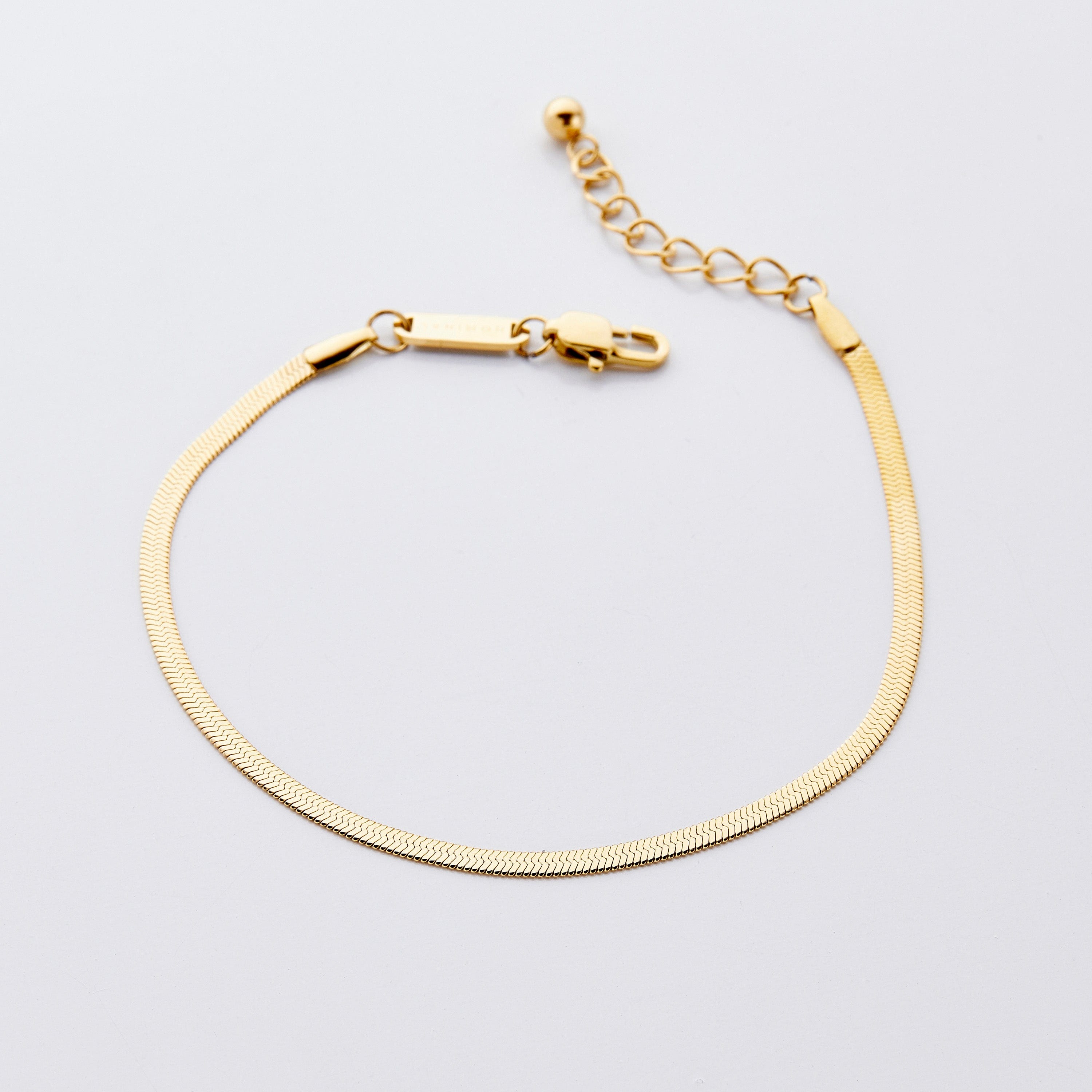 Close-up of the Liquid Gold Herringbone Chain Anklet showcasing its sleek design.