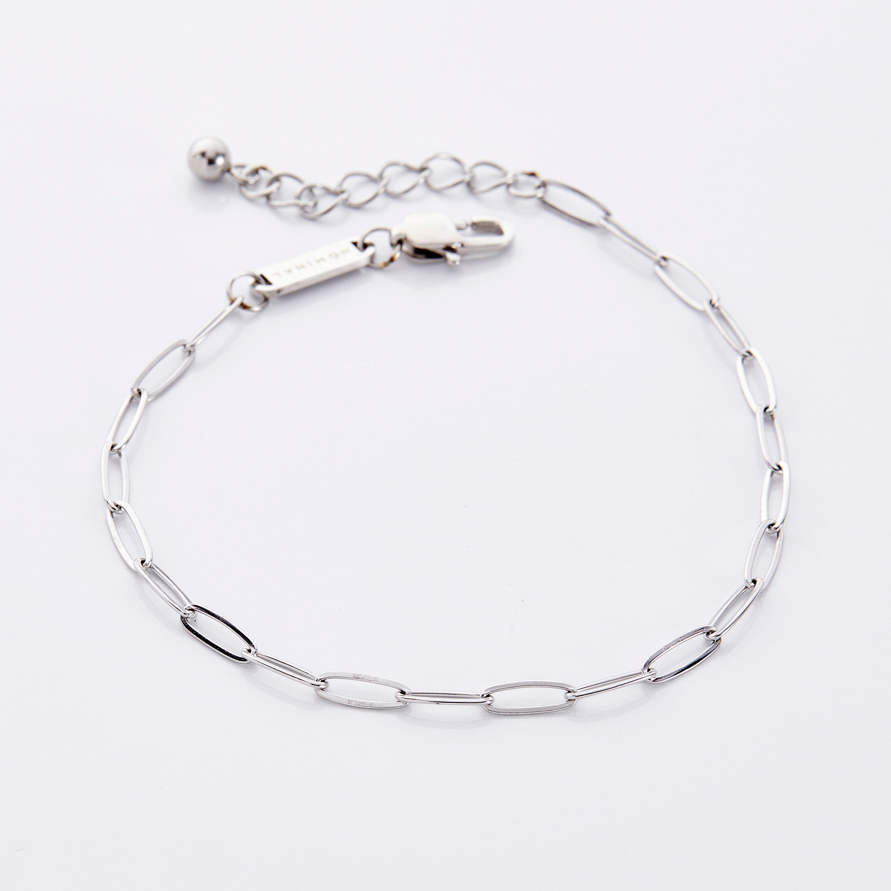 Detailed shot of the anklet in its velvet pouch, emphasizing the quality and warranty details.