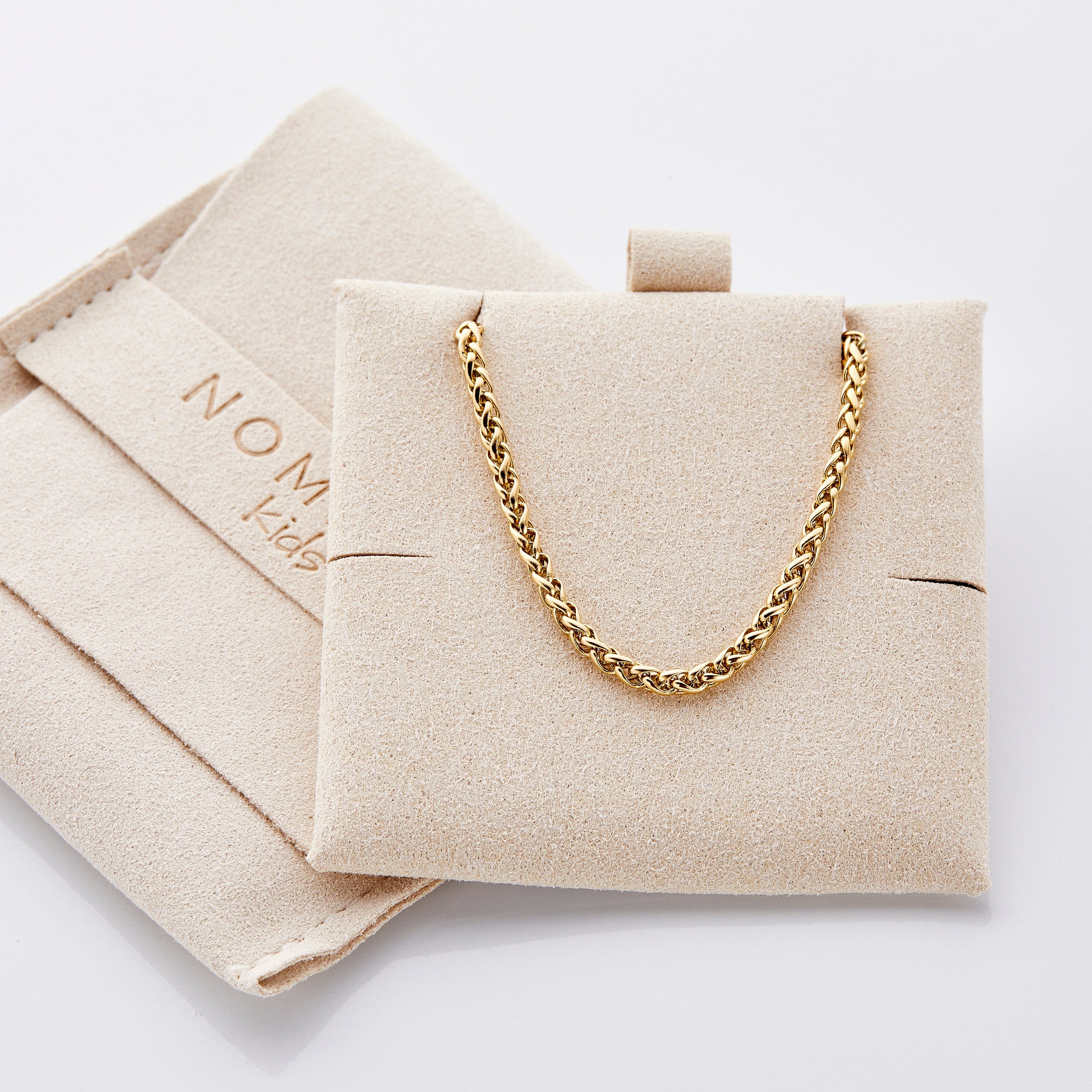 Close-up view of the 2.5MM thick wheat chain anklet on a models ankle.