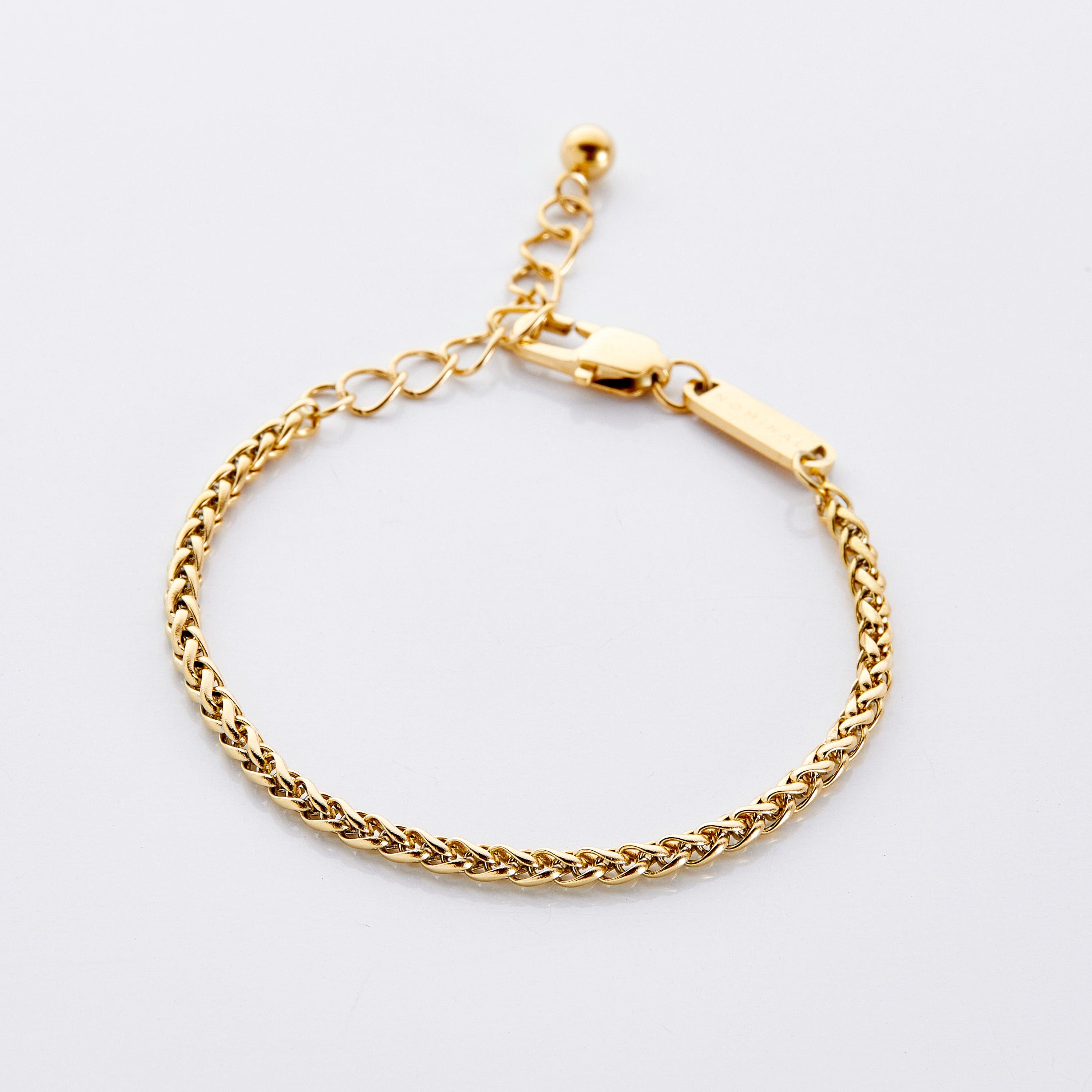 Close-up of the wheat chain bracelet showcasing its intricate design and gold finish.
