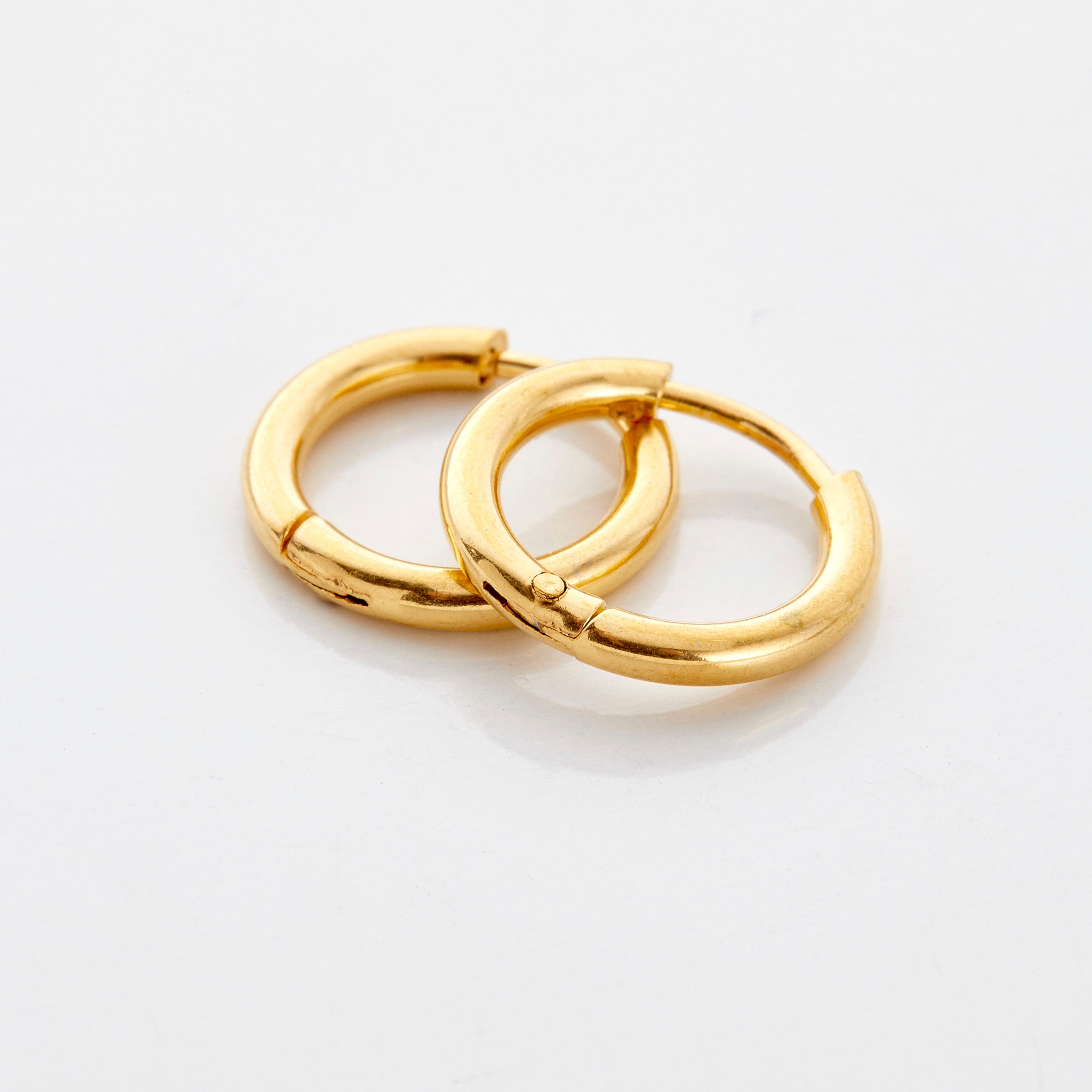 Close-up of glowing hoop earrings for girls, showcasing the gold finish and stainless steel.