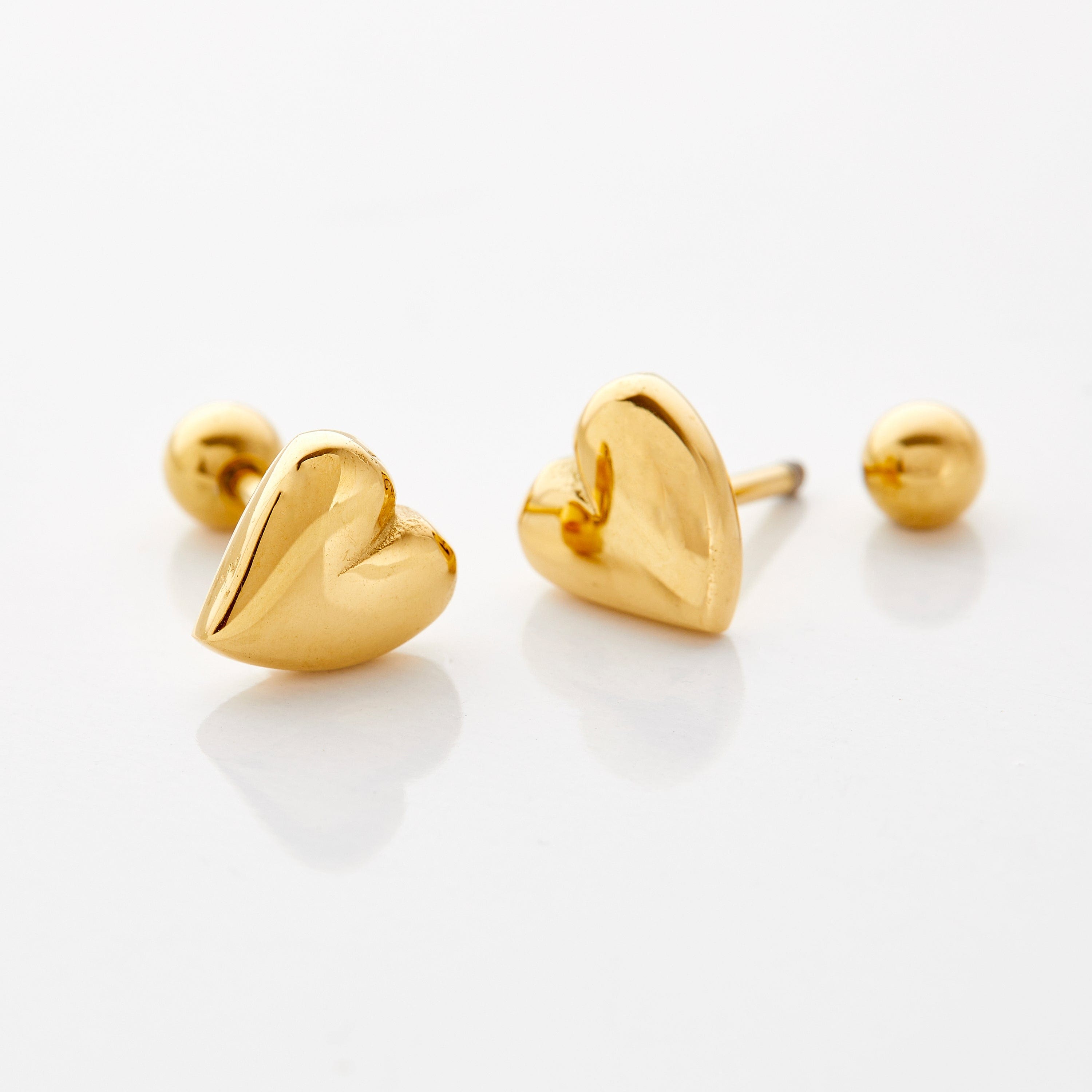 Close-up of adorable heart earrings for girls showing detail and shine.