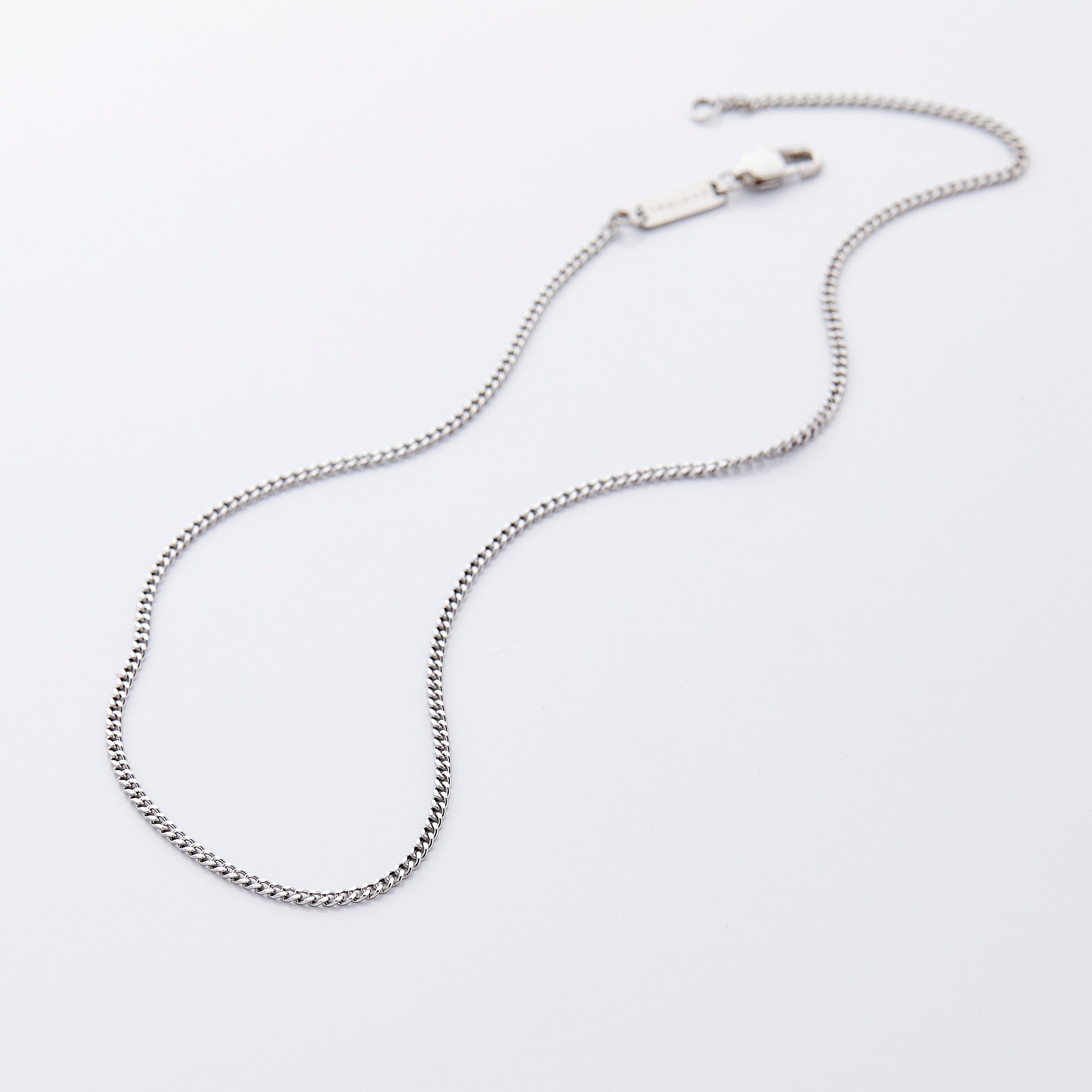 Close-up of the gold Cuban chain necklace showcasing its uniform links and shine.