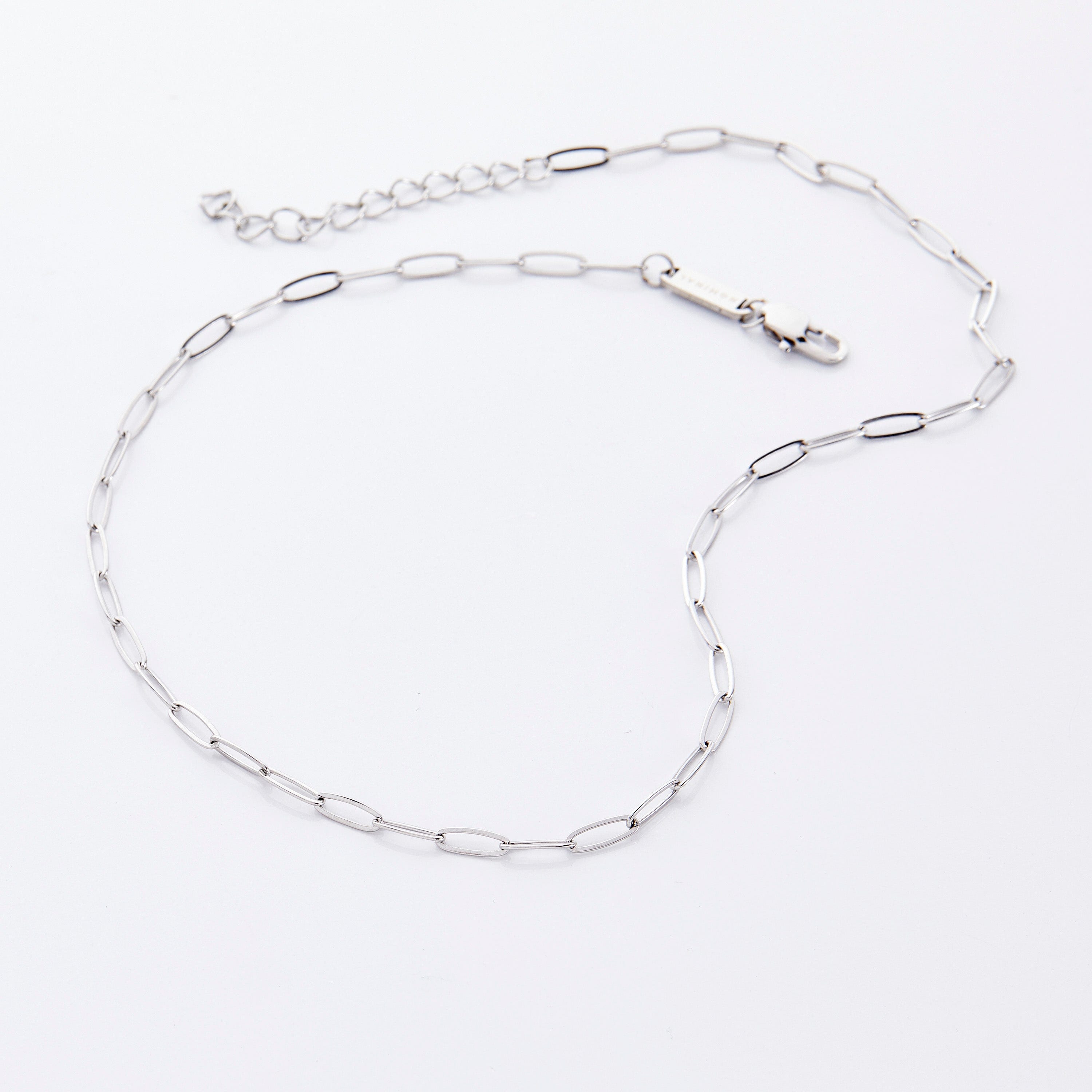 Packaging of the Timeless Link Chain Necklace in a velvet drawstring pouch.