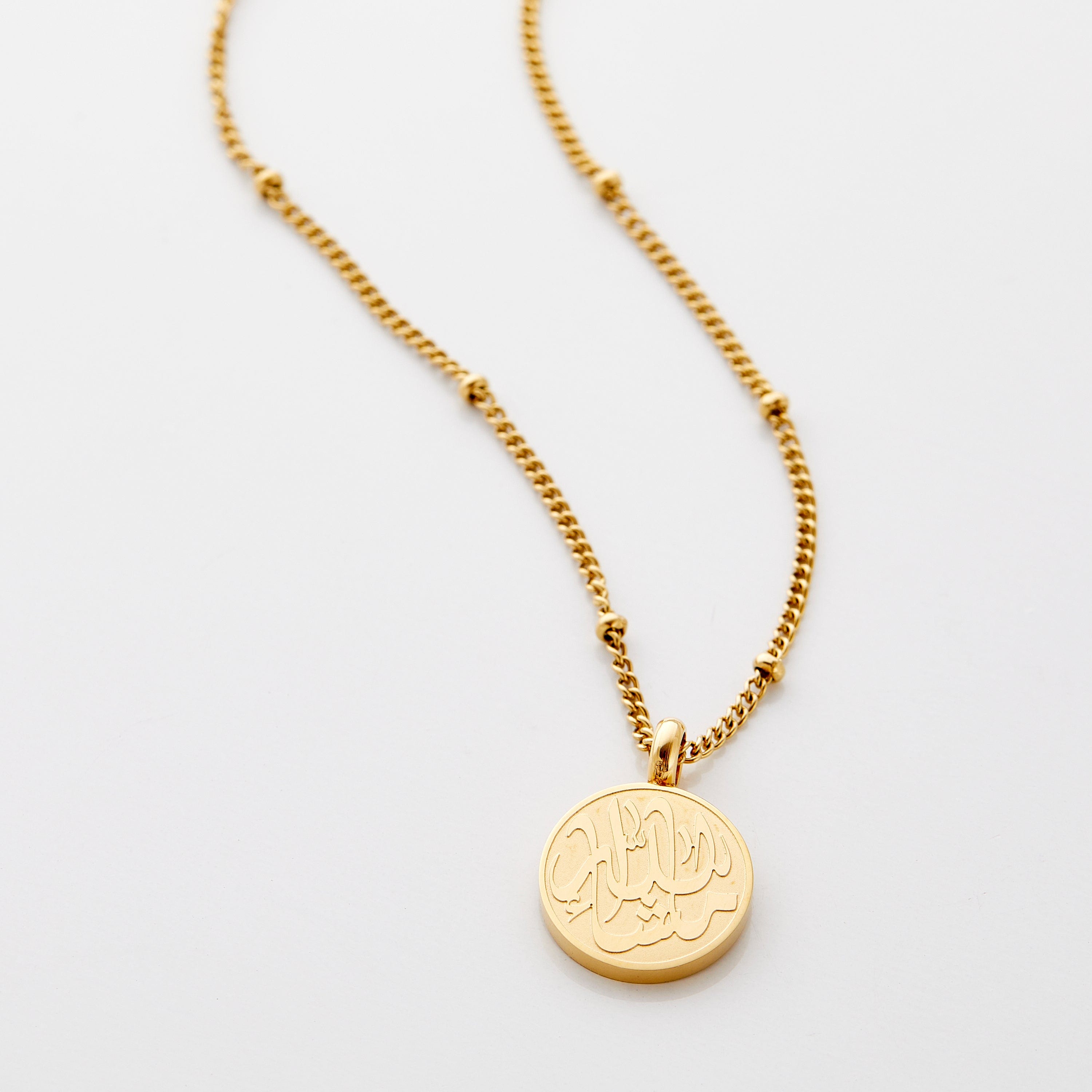 Close-up view of the MashaAllah token necklace showcasing its elegant pendant design.