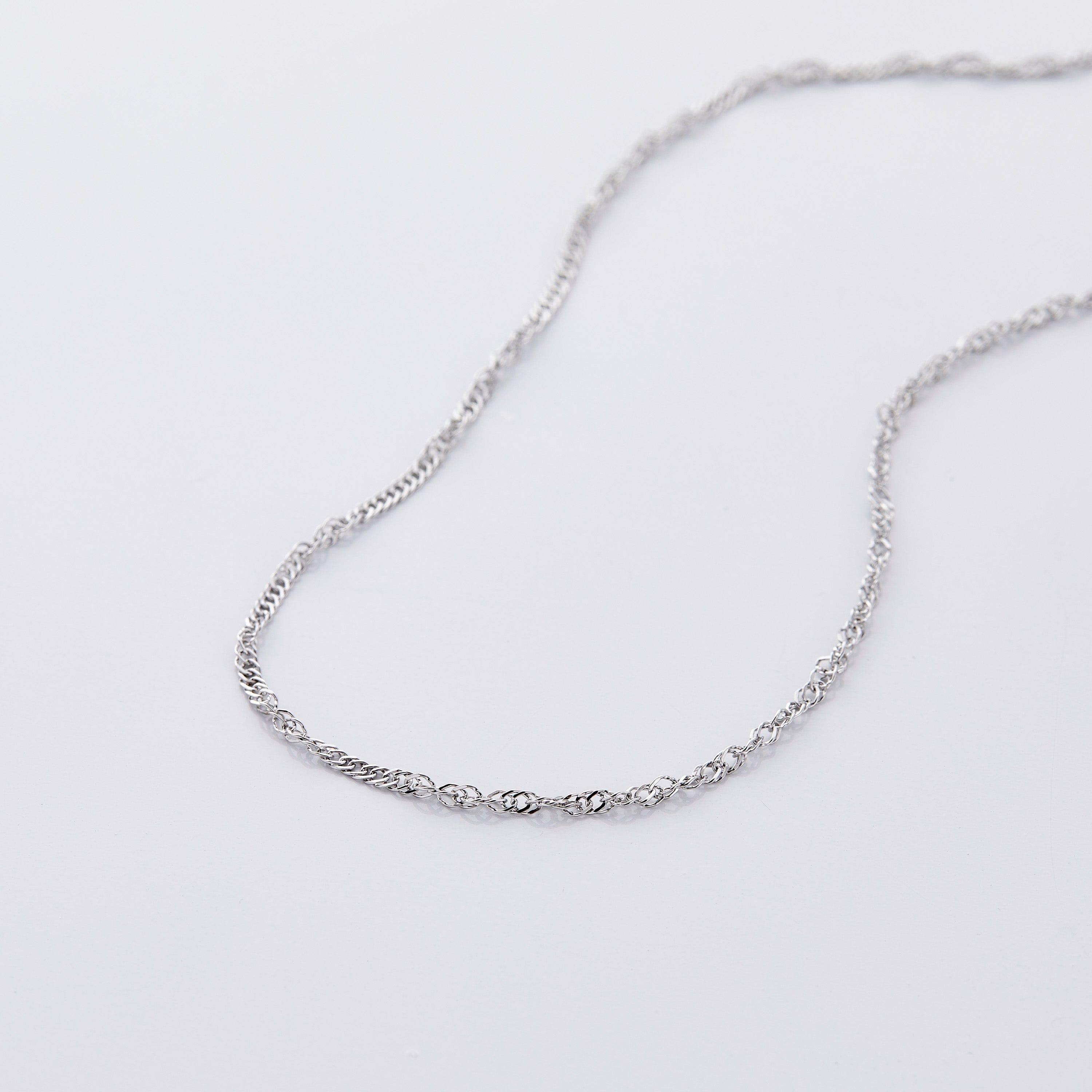 A little girl wearing the twisted chain necklace, radiating confidence at a birthday party.