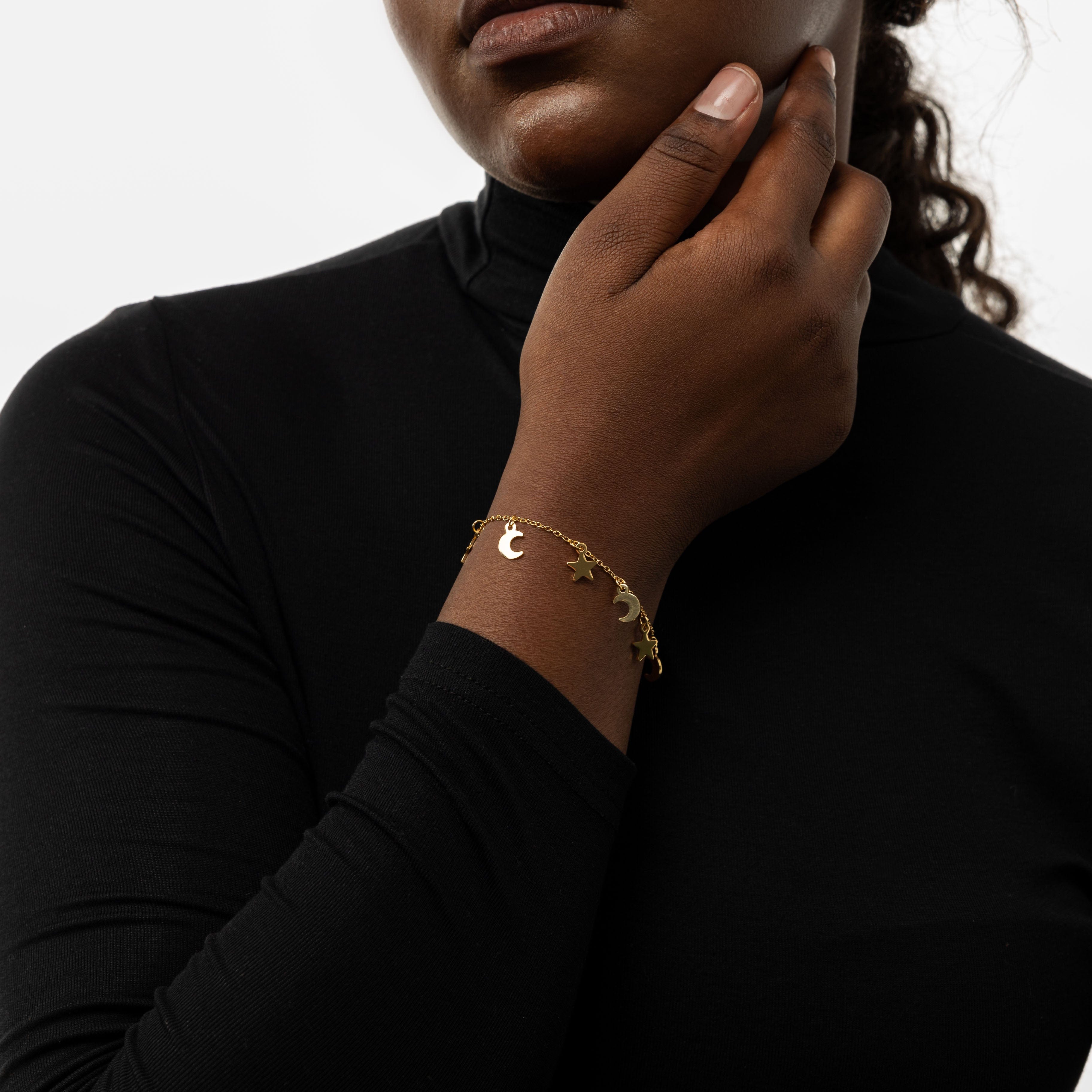 Model wearing the Celestial Elegance Gold Bracelet, demonstrating its versatility with a casual outfit.