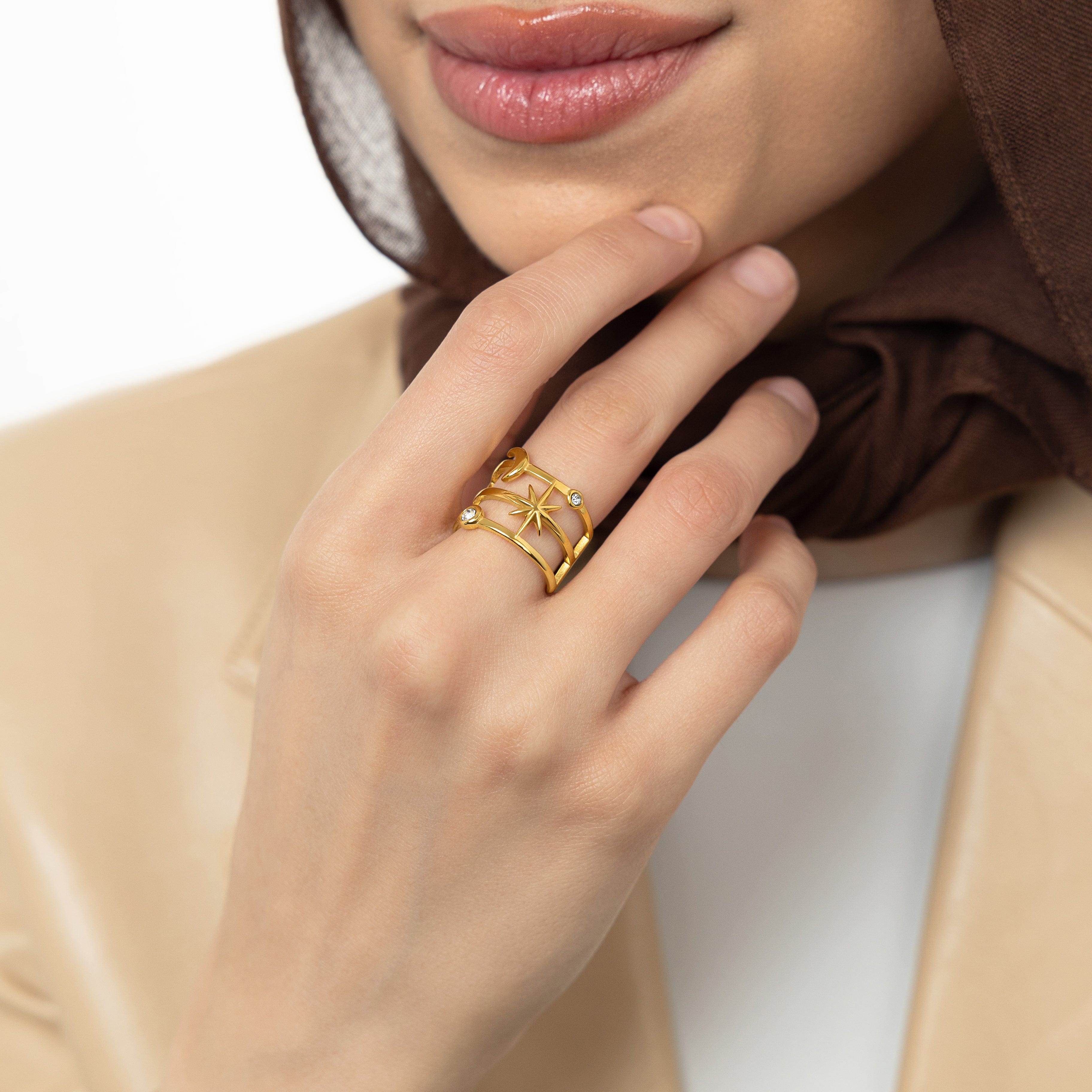 Close-up of the Celestial Luminous Stack Ring against a velvet pouch, emphasizing its gold plating and shine.