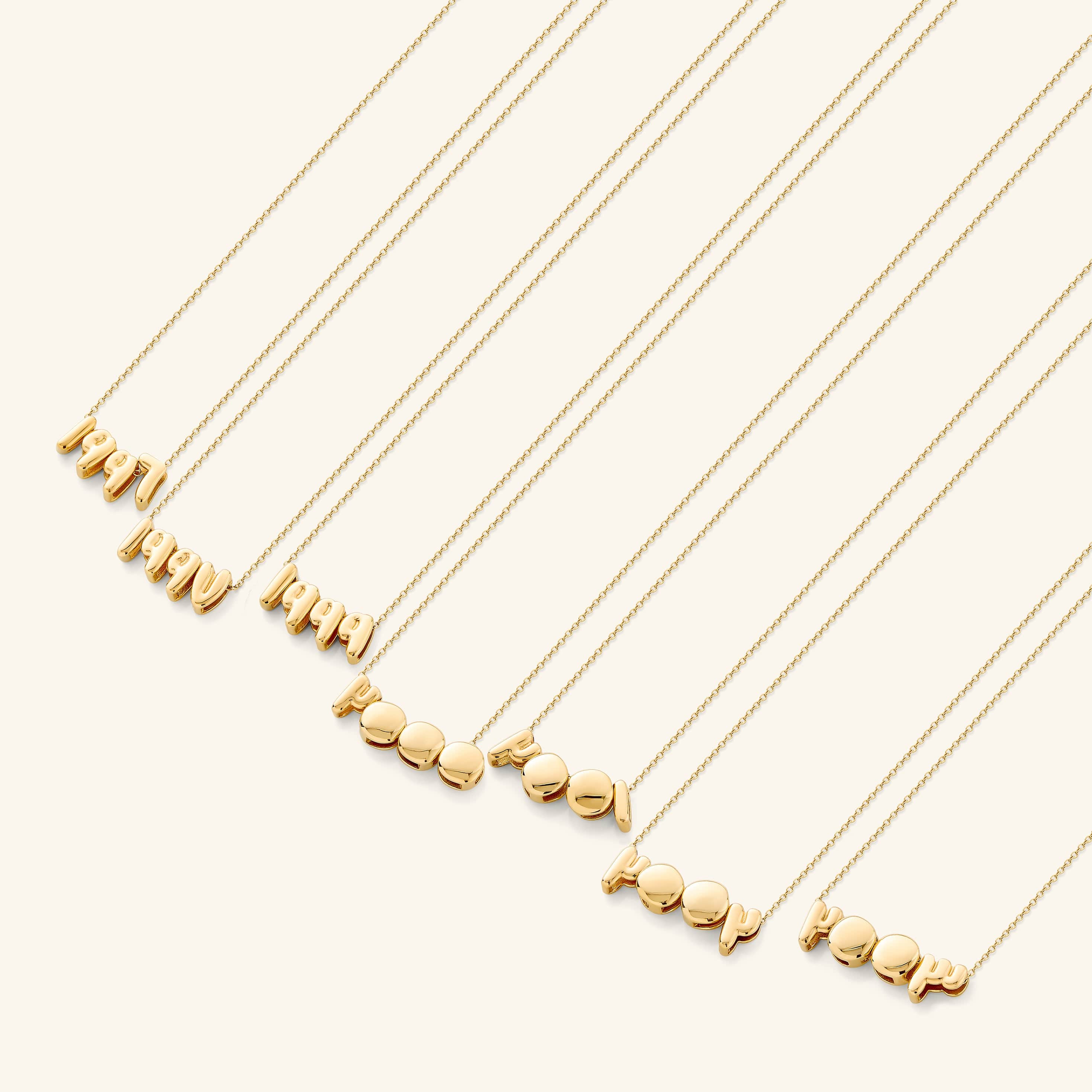 A woman wearing the Arabic birthyear necklace, emphasizing its stylish appeal and versatility.