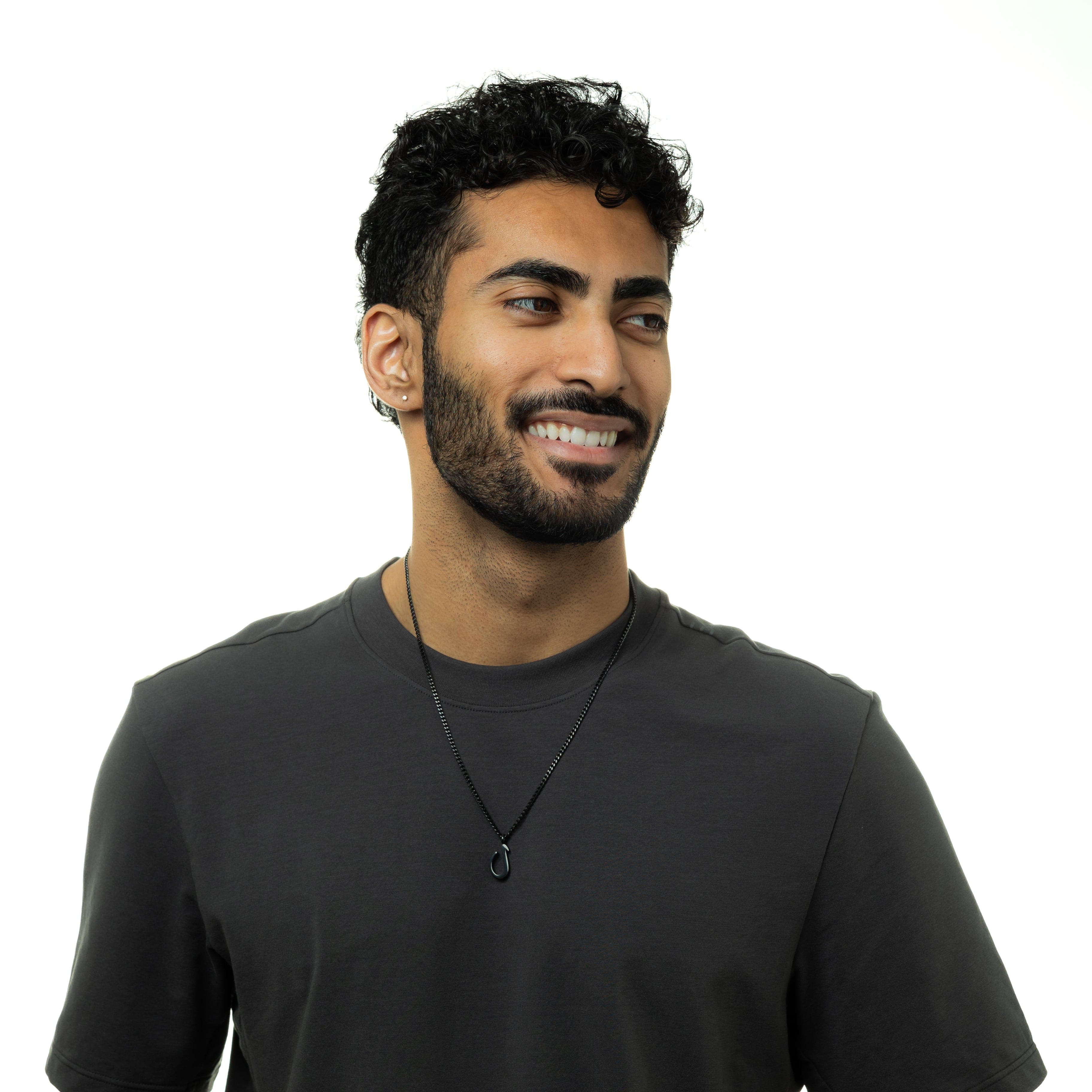 Man wearing the Arabic letter necklace, demonstrating its perfect fit and stylish appeal.