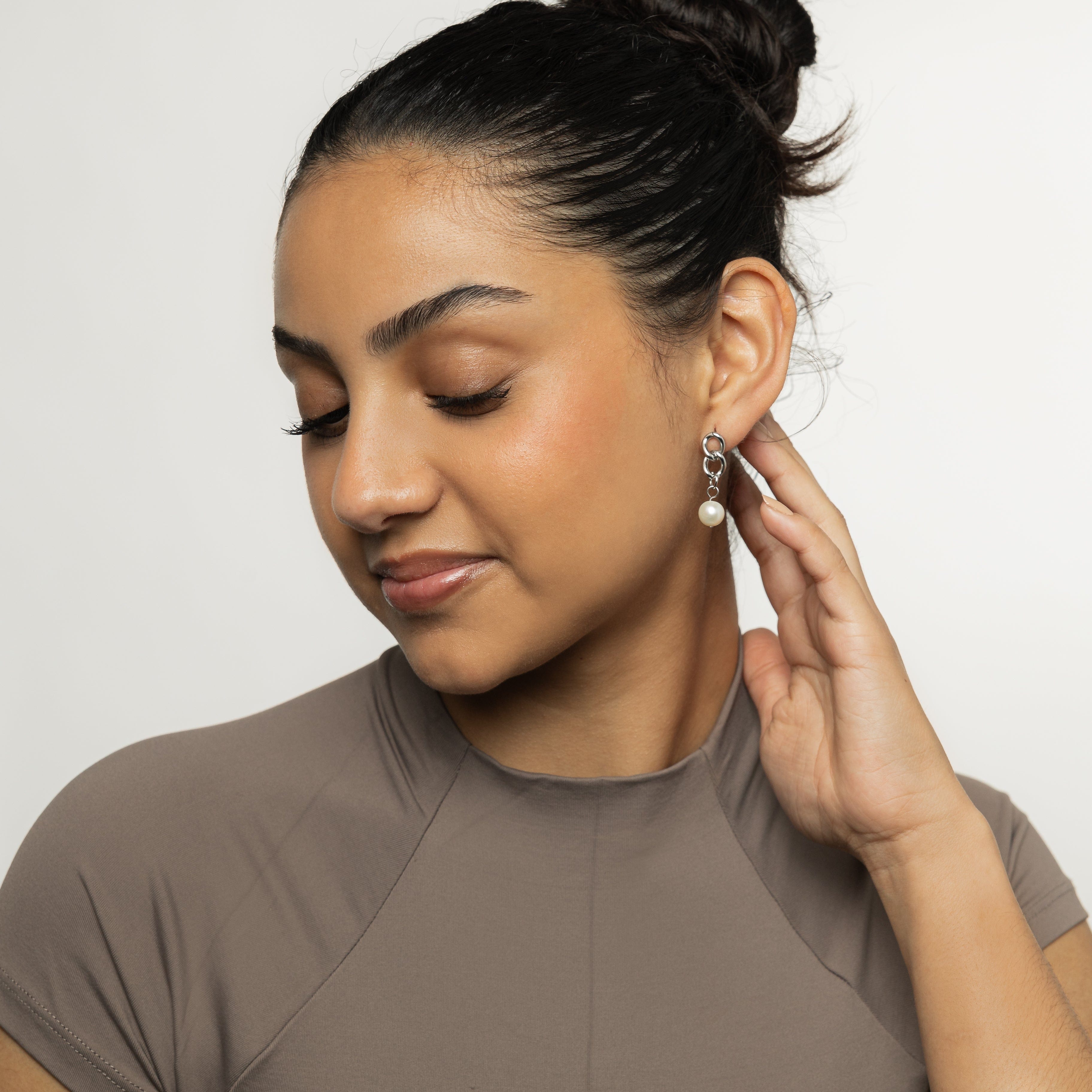 Elegant Hanging Pearl Earrings from a side angle showcasing the gold-plated finish and round pearls.
