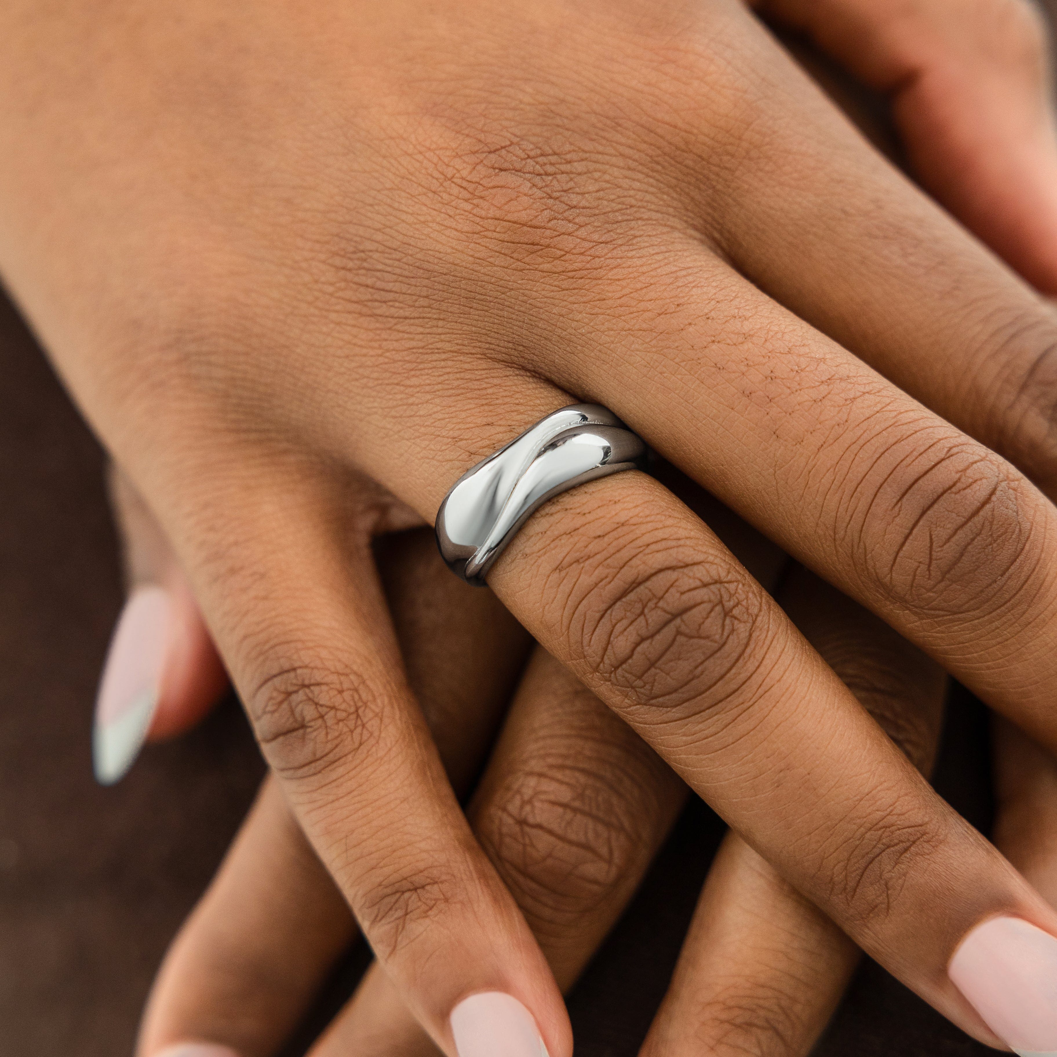 Fluid Harmony Stackable Ring displayed elegantly on a finger, showcasing its dainty design.
