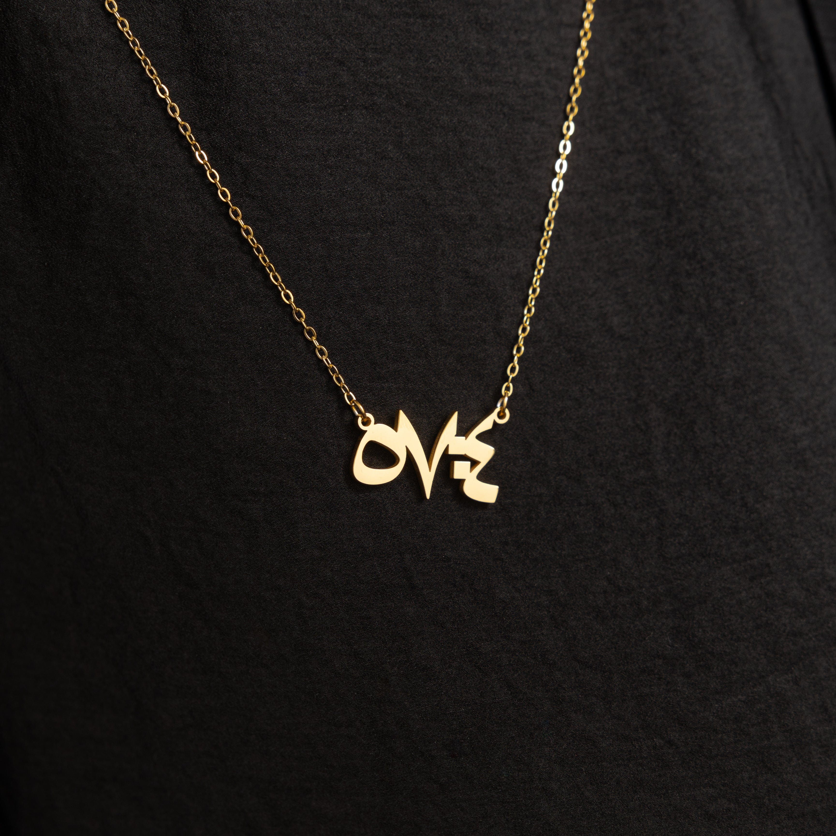 Close-up of the pendant featuring Arabic numerals and gold plating, showcasing intricate details.