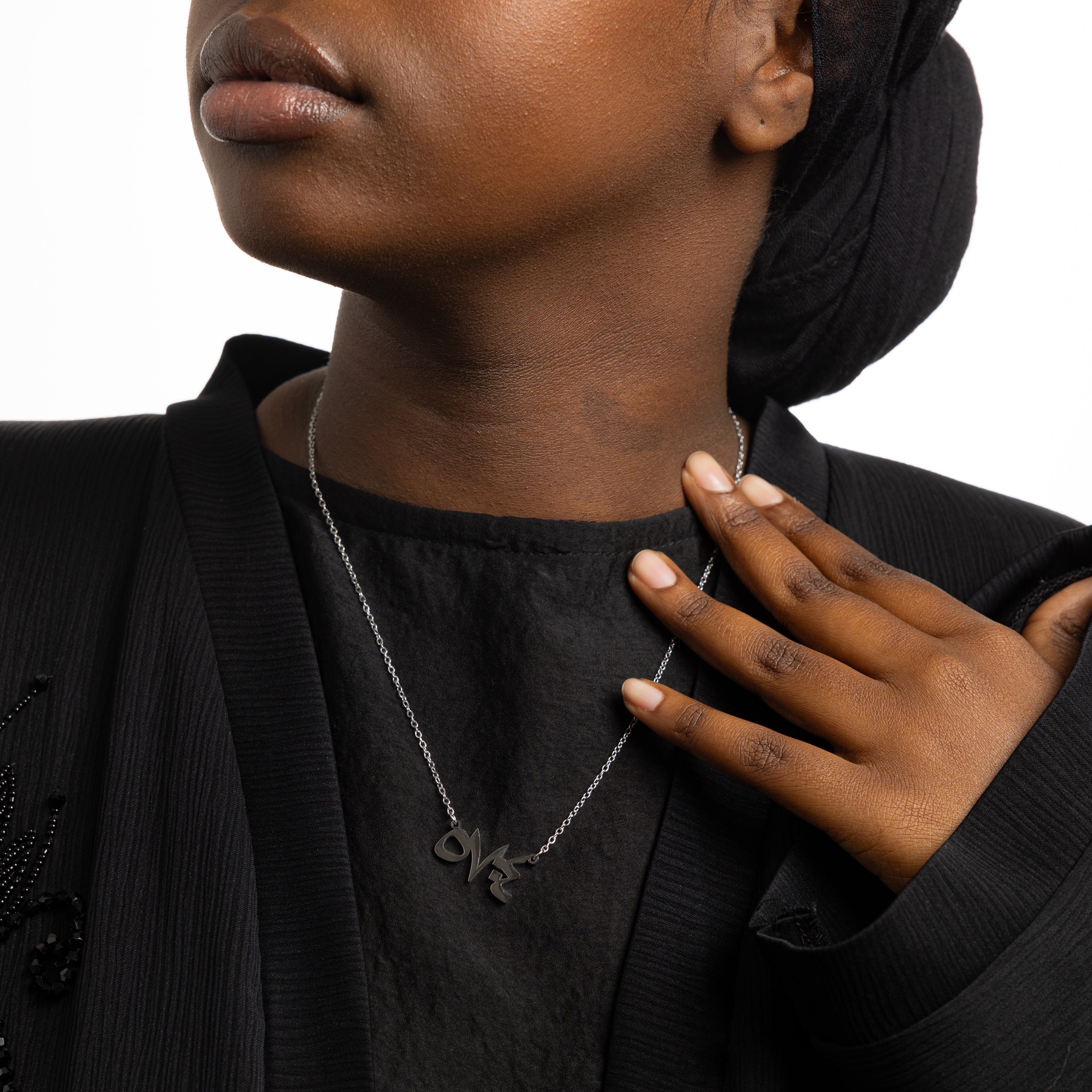 Close-up of the pendant featuring Arabic numerals and gold plating, showcasing intricate details.