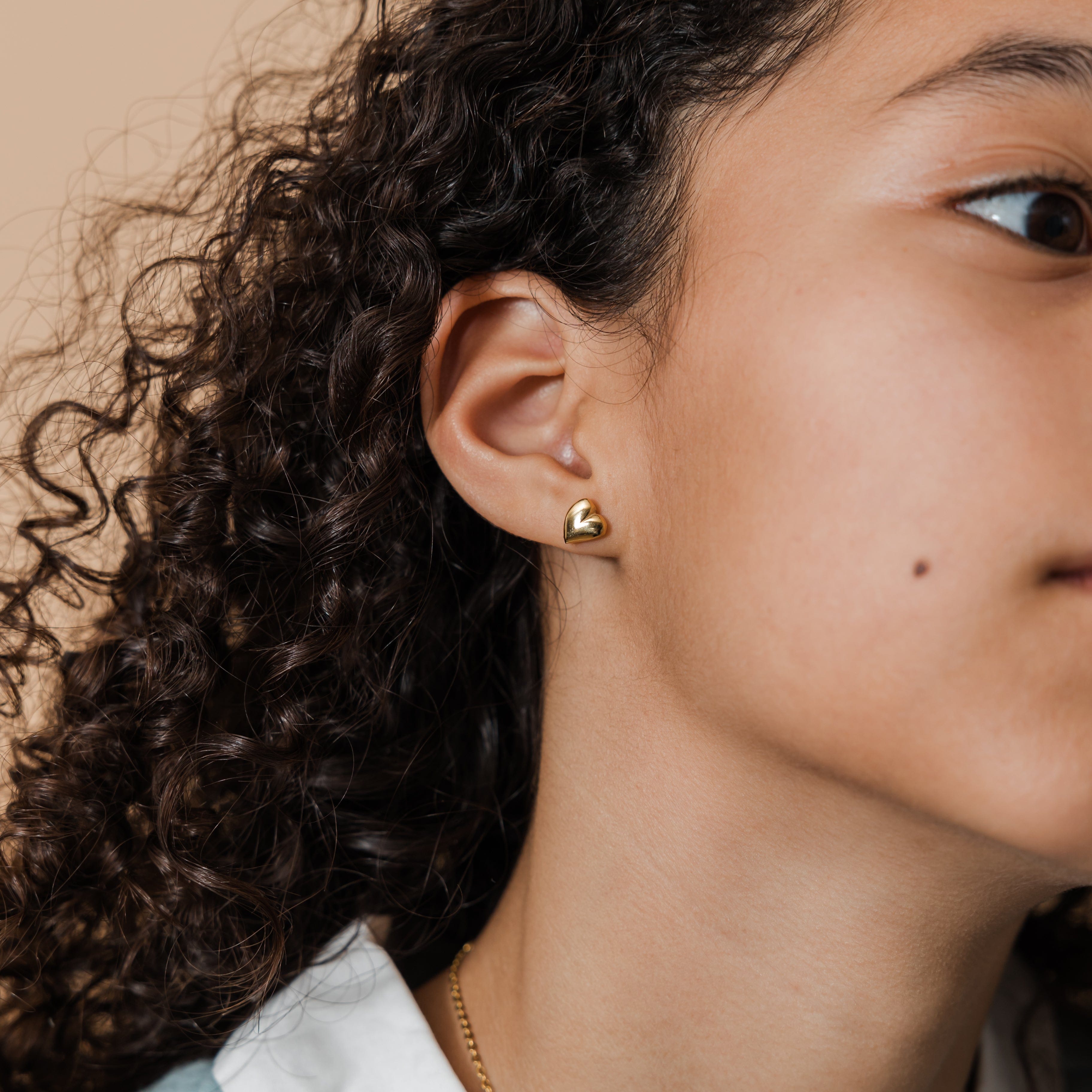 Heart earrings displayed in a velvet pouch, ideal for gifting.