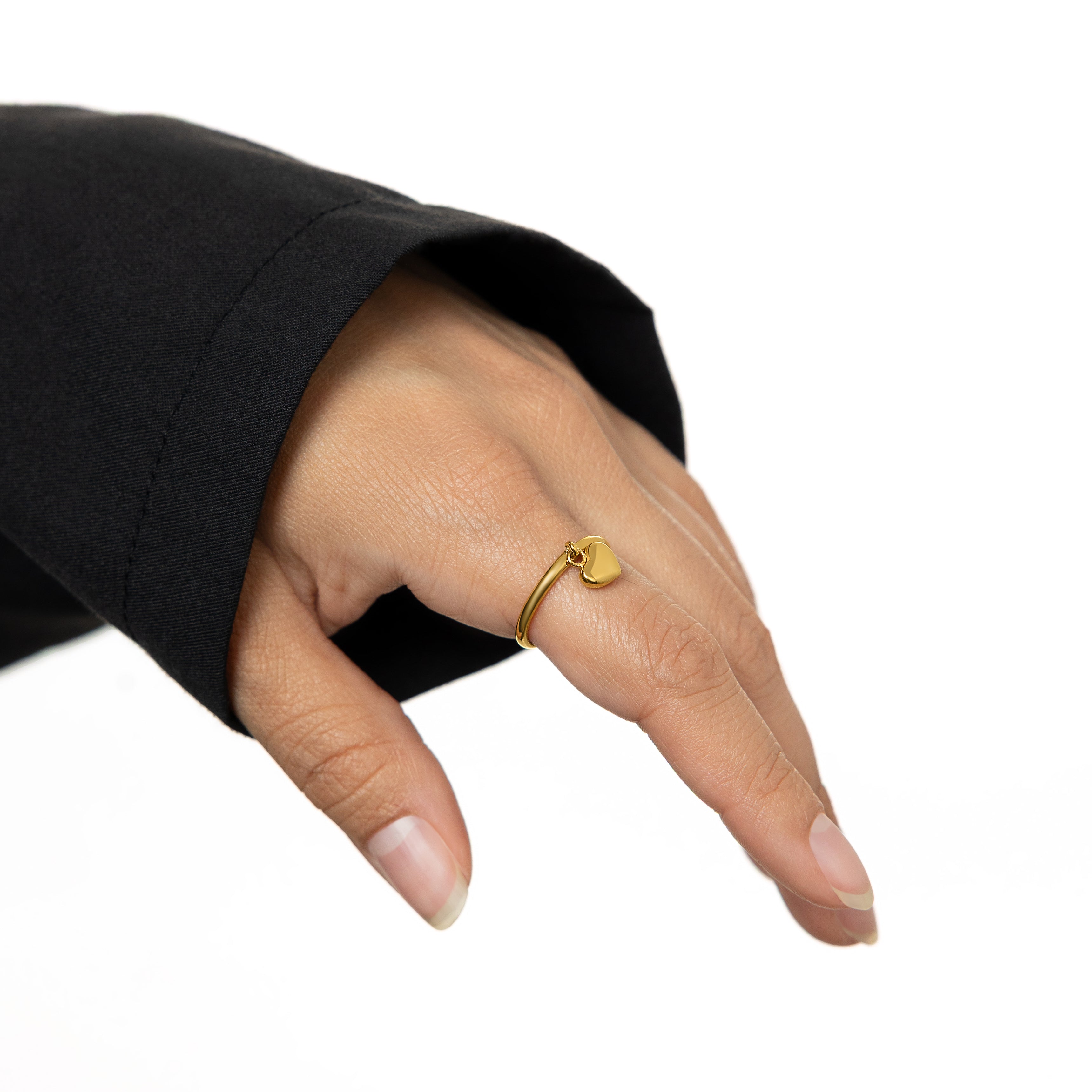 Elegant Gold Heart Loop Ring on a hand, showcasing its minimalist design.