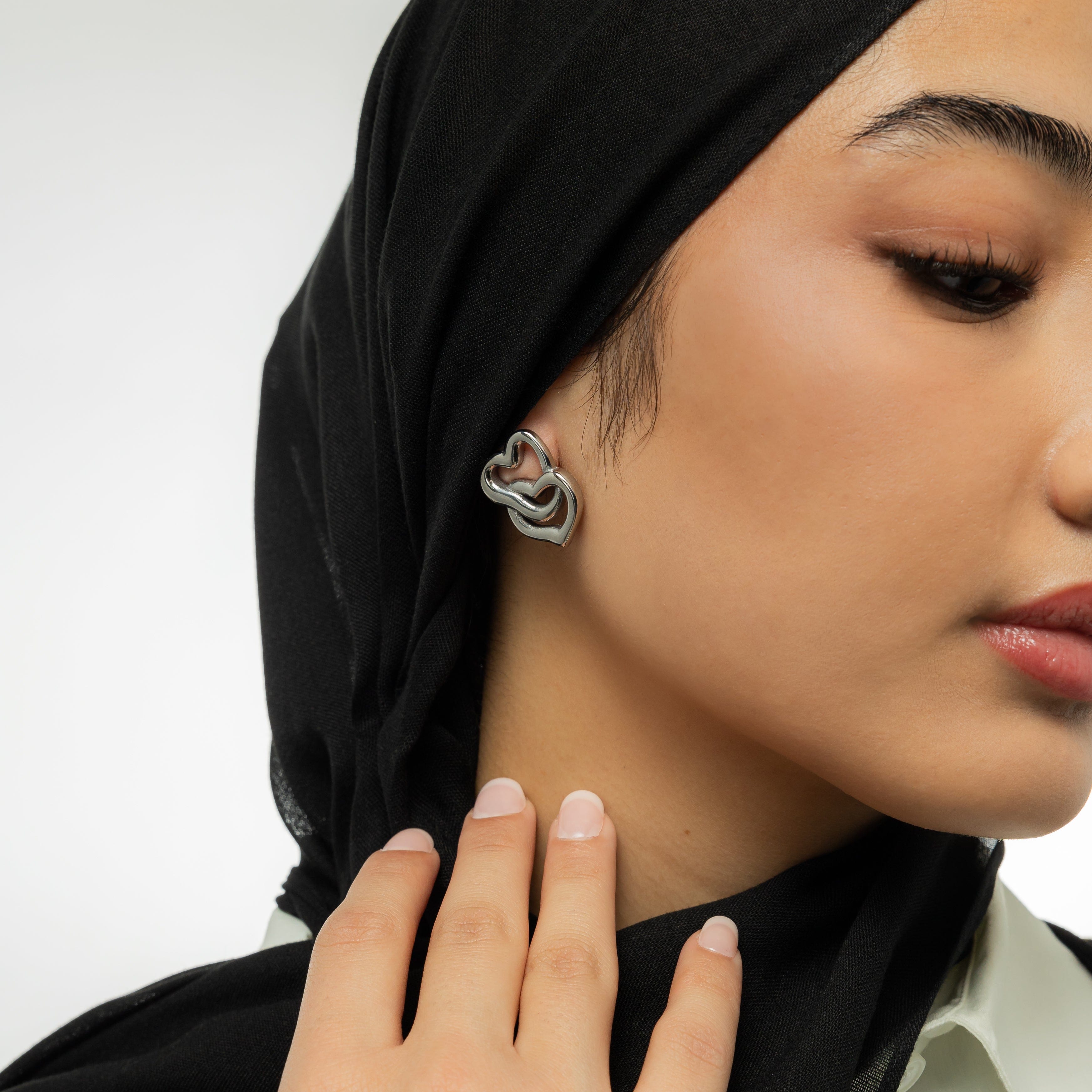 LoveFusion Statement Earrings displayed in a velvet pouch, highlighting their elegant style.