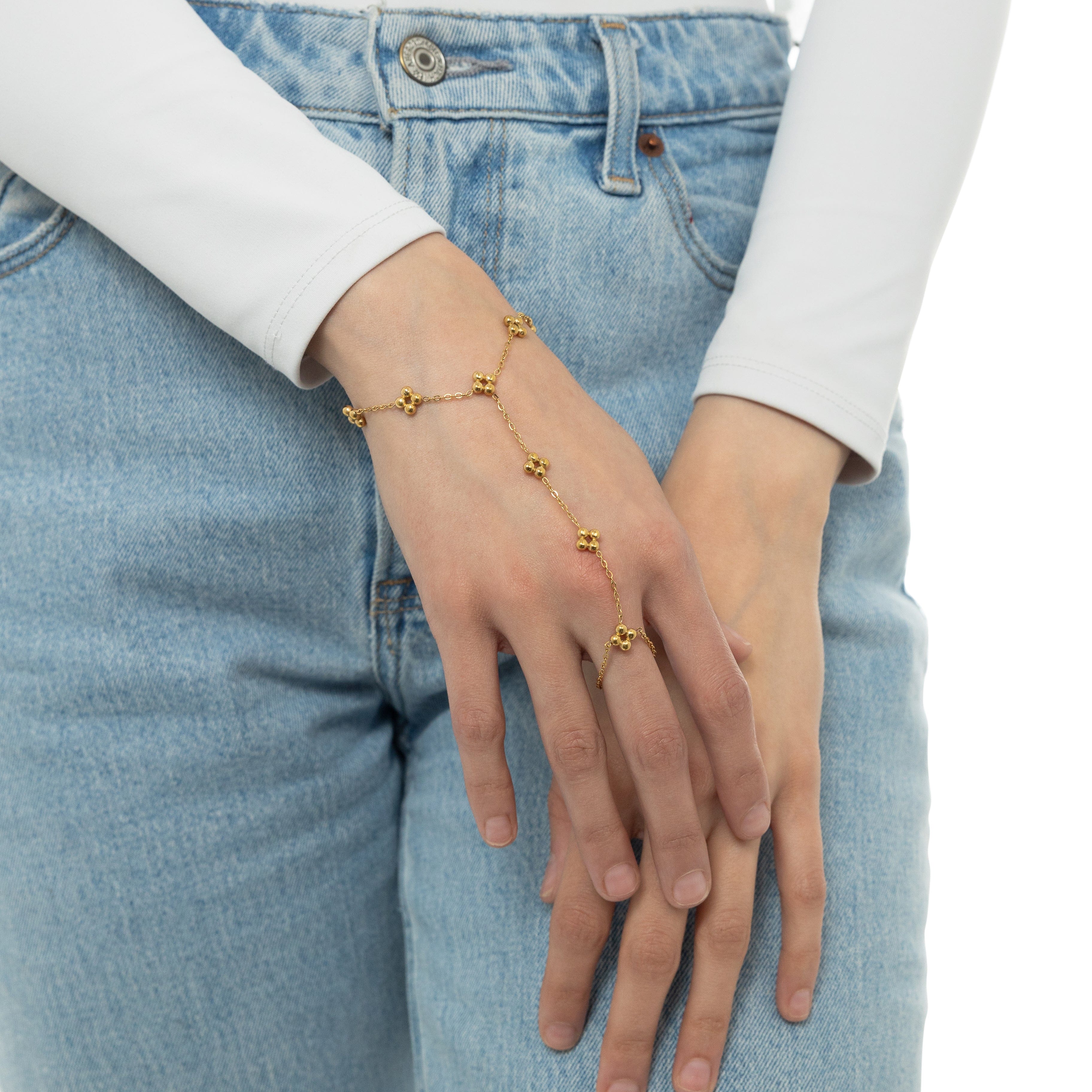 Flat lay of the gold plated henna hand chain with a velvet pouch.