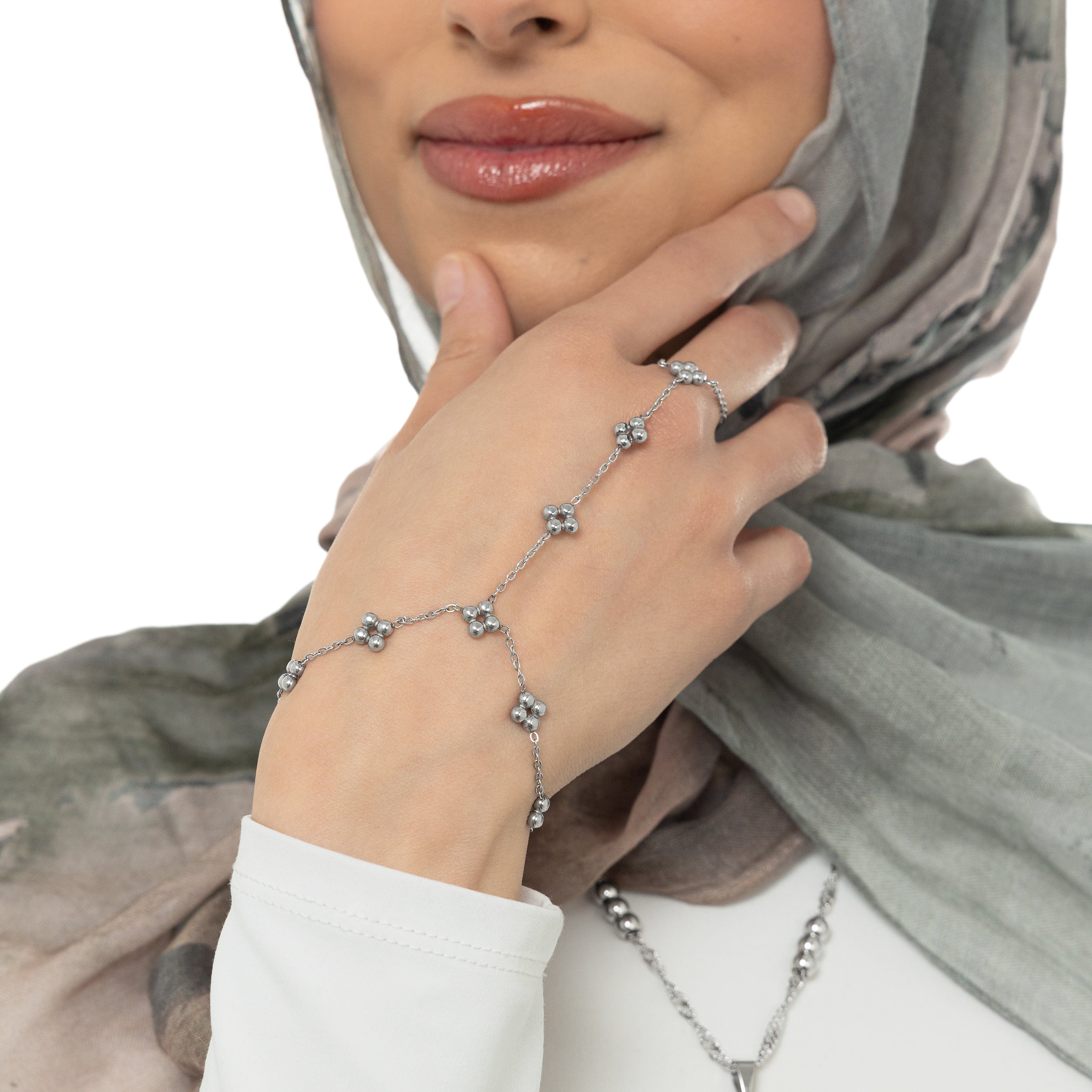 Flat lay of the gold plated henna hand chain with a velvet pouch.