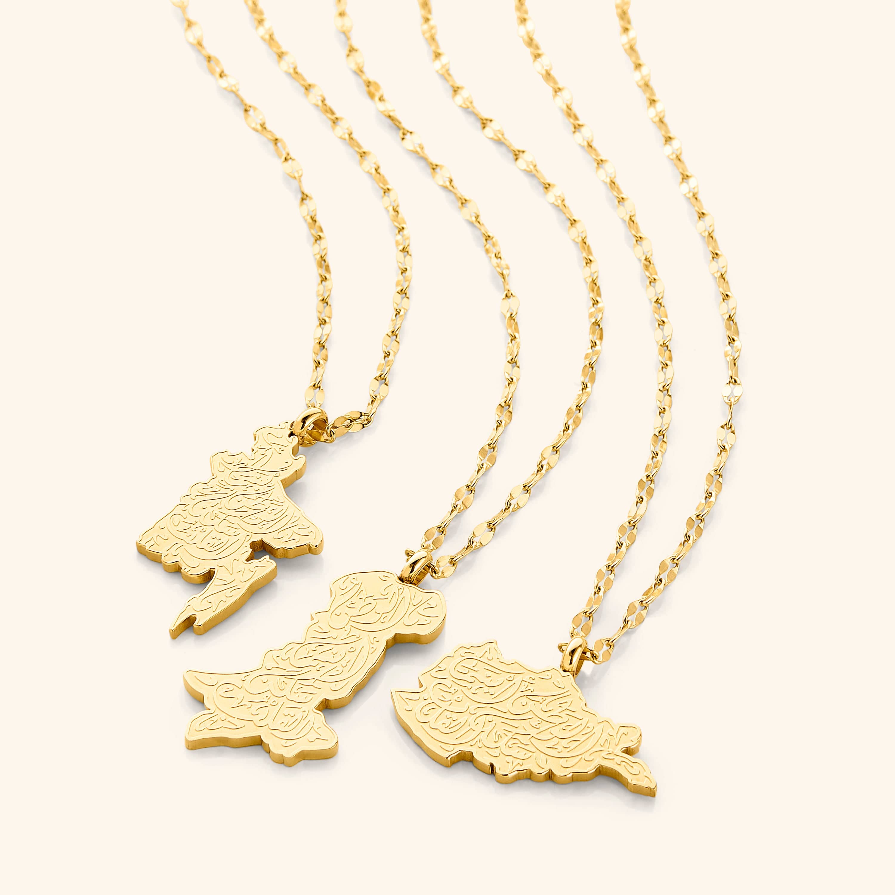 Close-up of the custom map necklace showcasing the gold pendant and engraving.