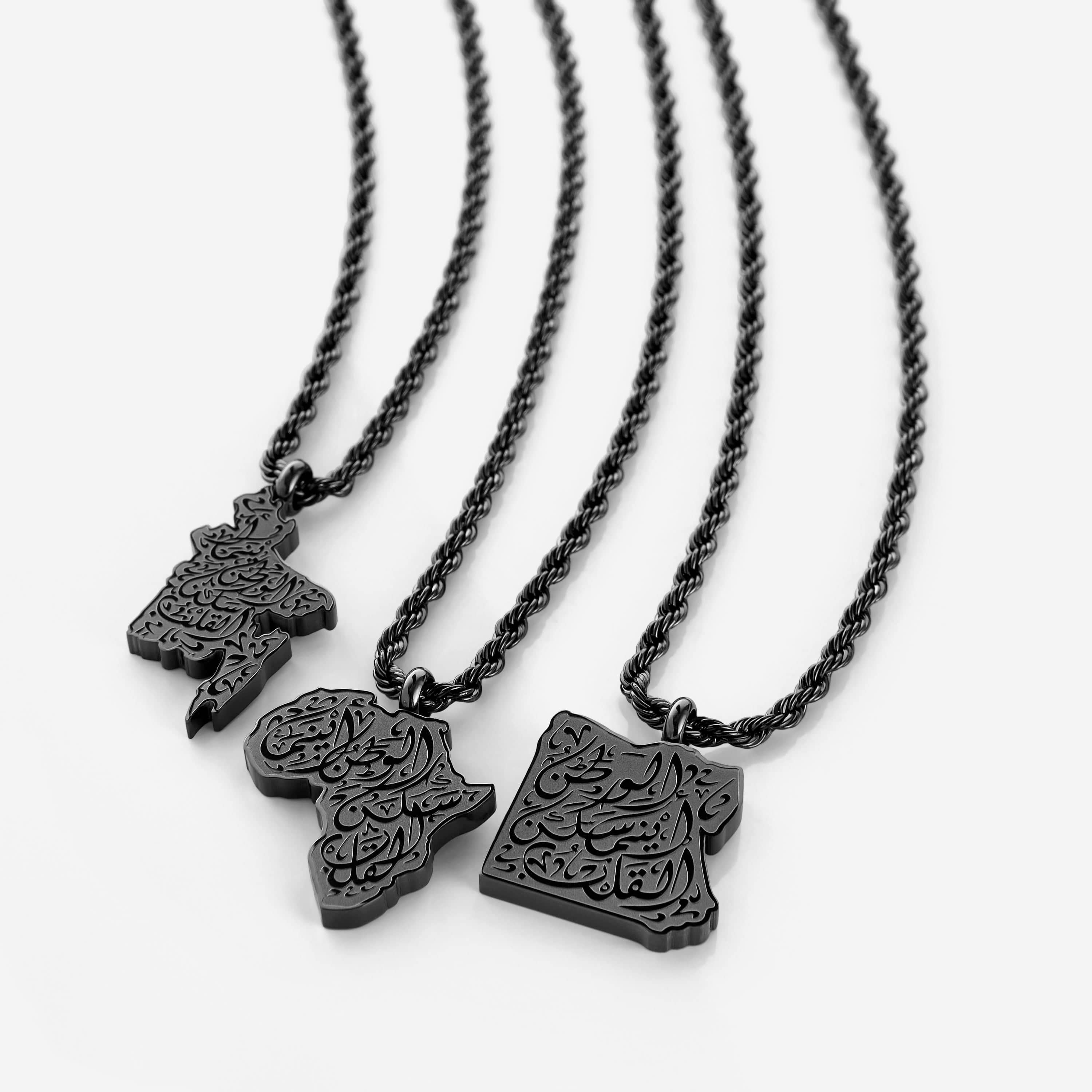 Close-up of the engraved hometown necklace highlighting Arabic calligraphy.