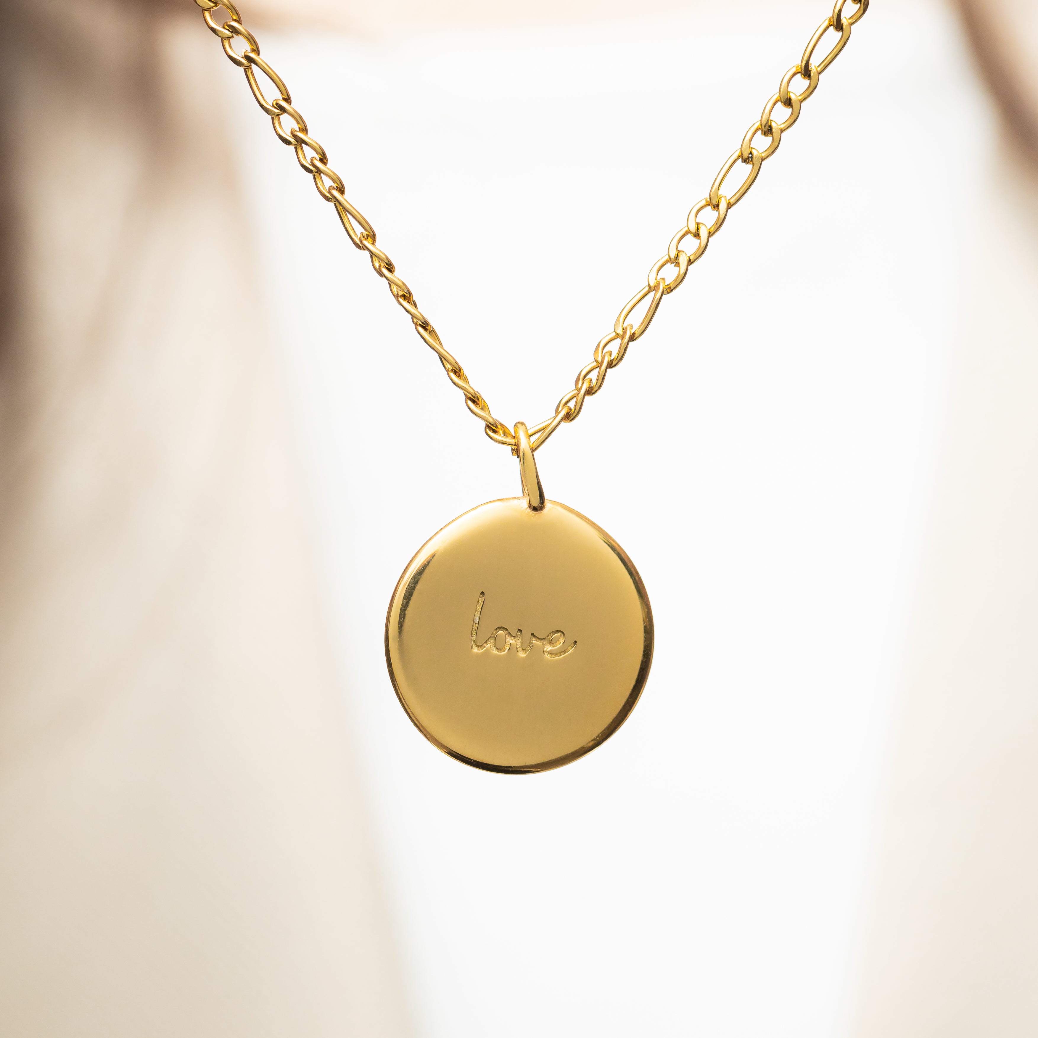 Eternal Love Charm showcasing intricate engraving in Arabic and English.